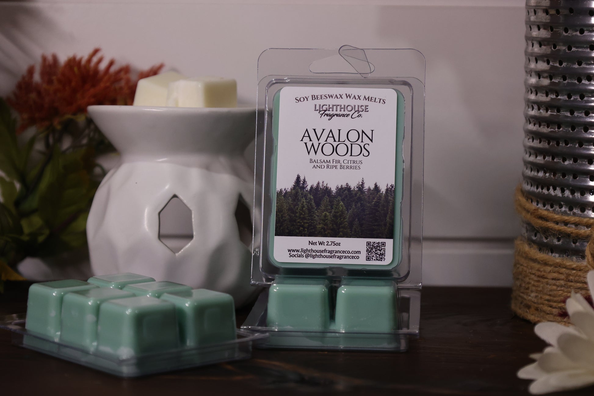 Packaged wax melts with 'Avalon Woods' label in front of a white wax warmer.