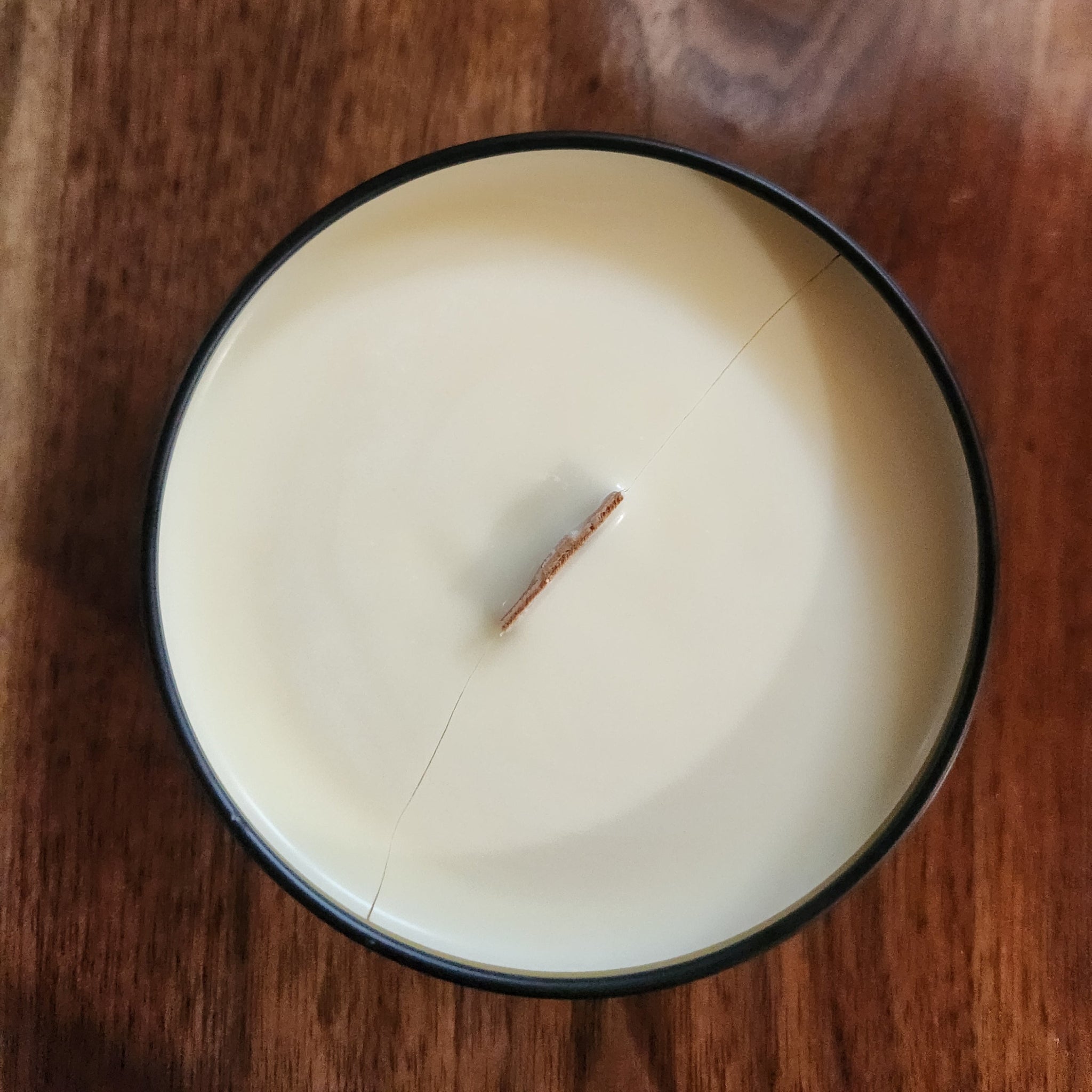 Off white candle in a tin