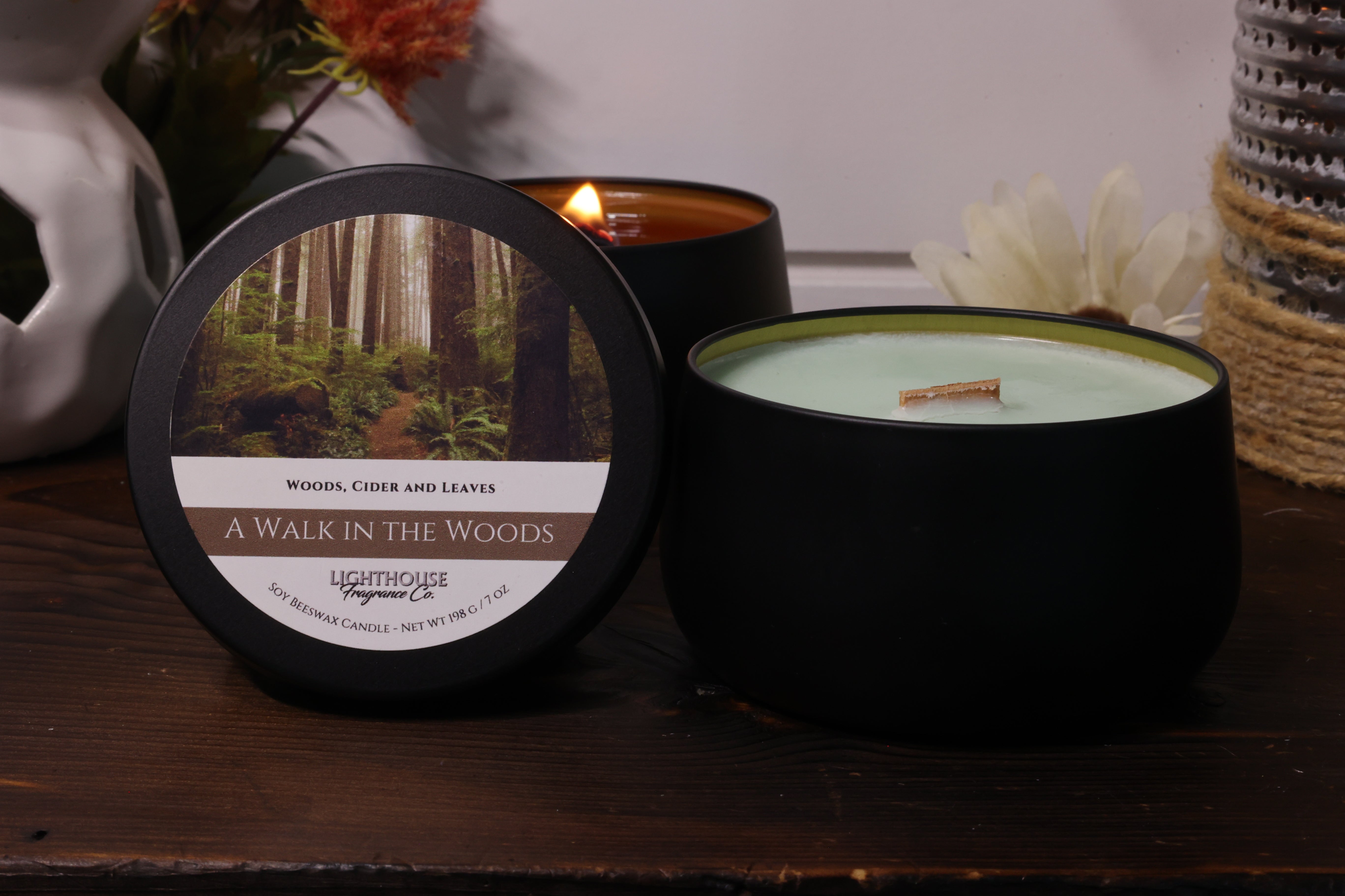 Candle with a labeled lid on a wooden surface
