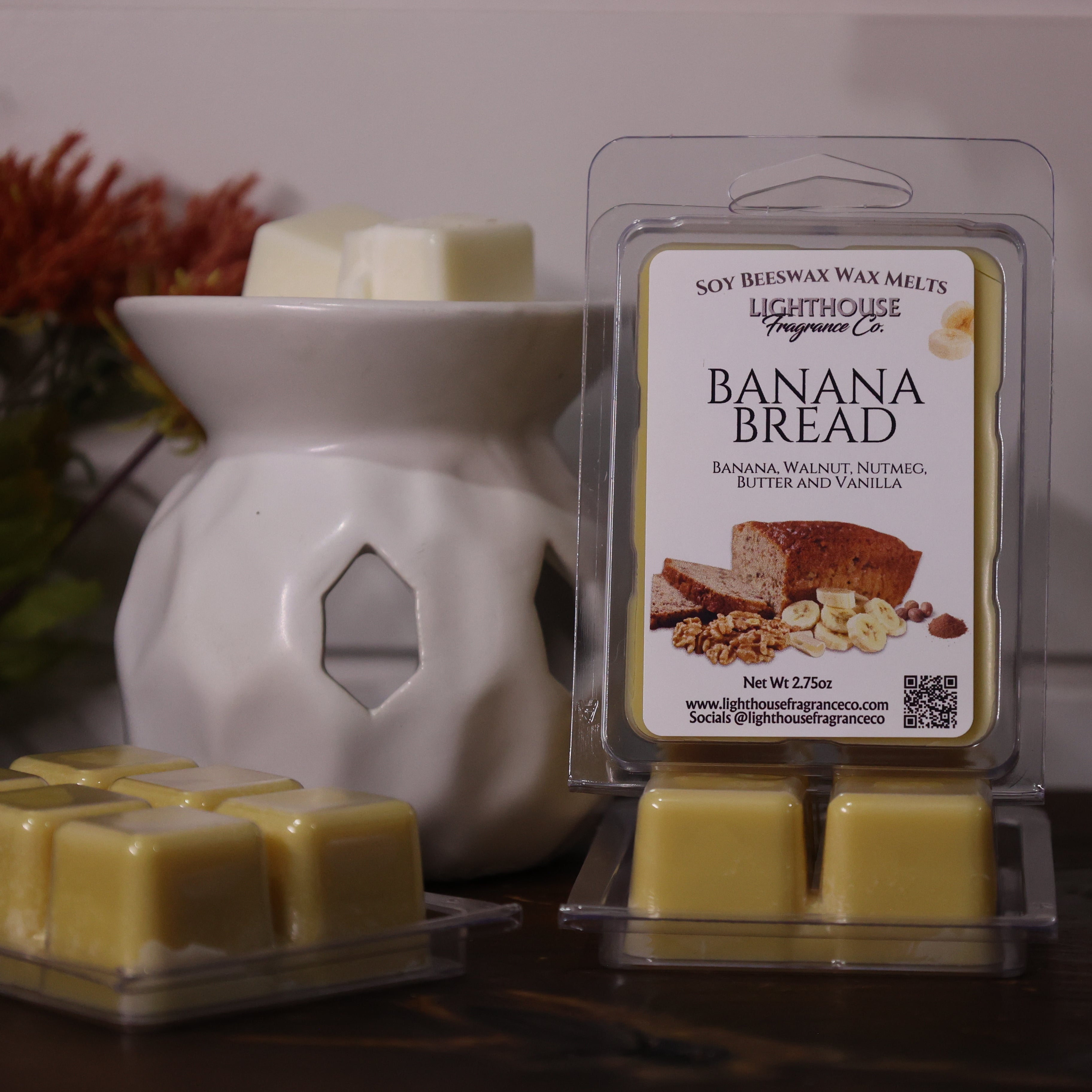 Banana bread scented wax melts with packaging in front of a wax warmer.