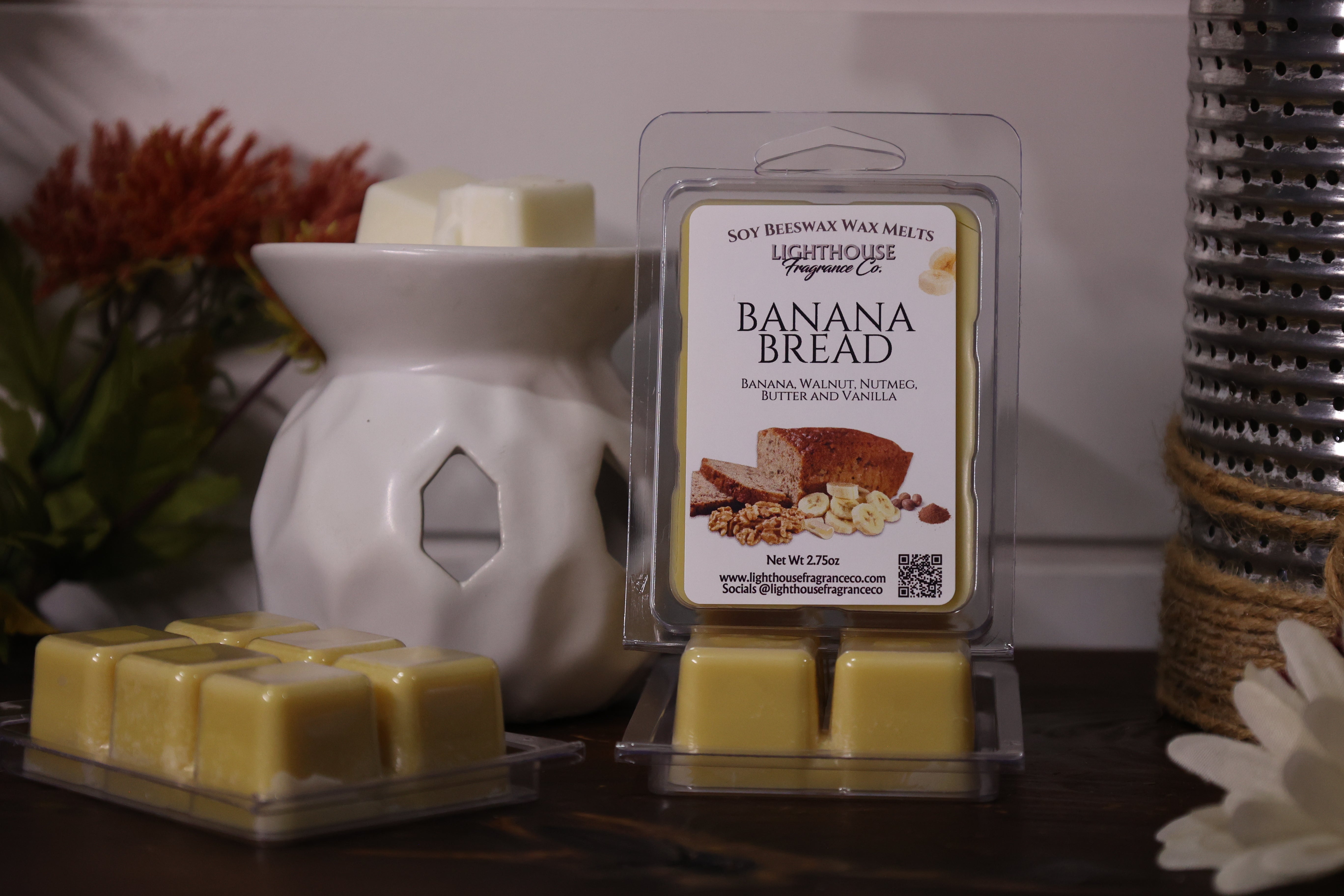 Banana bread scented wax melts with packaging in front of a wax warmer.