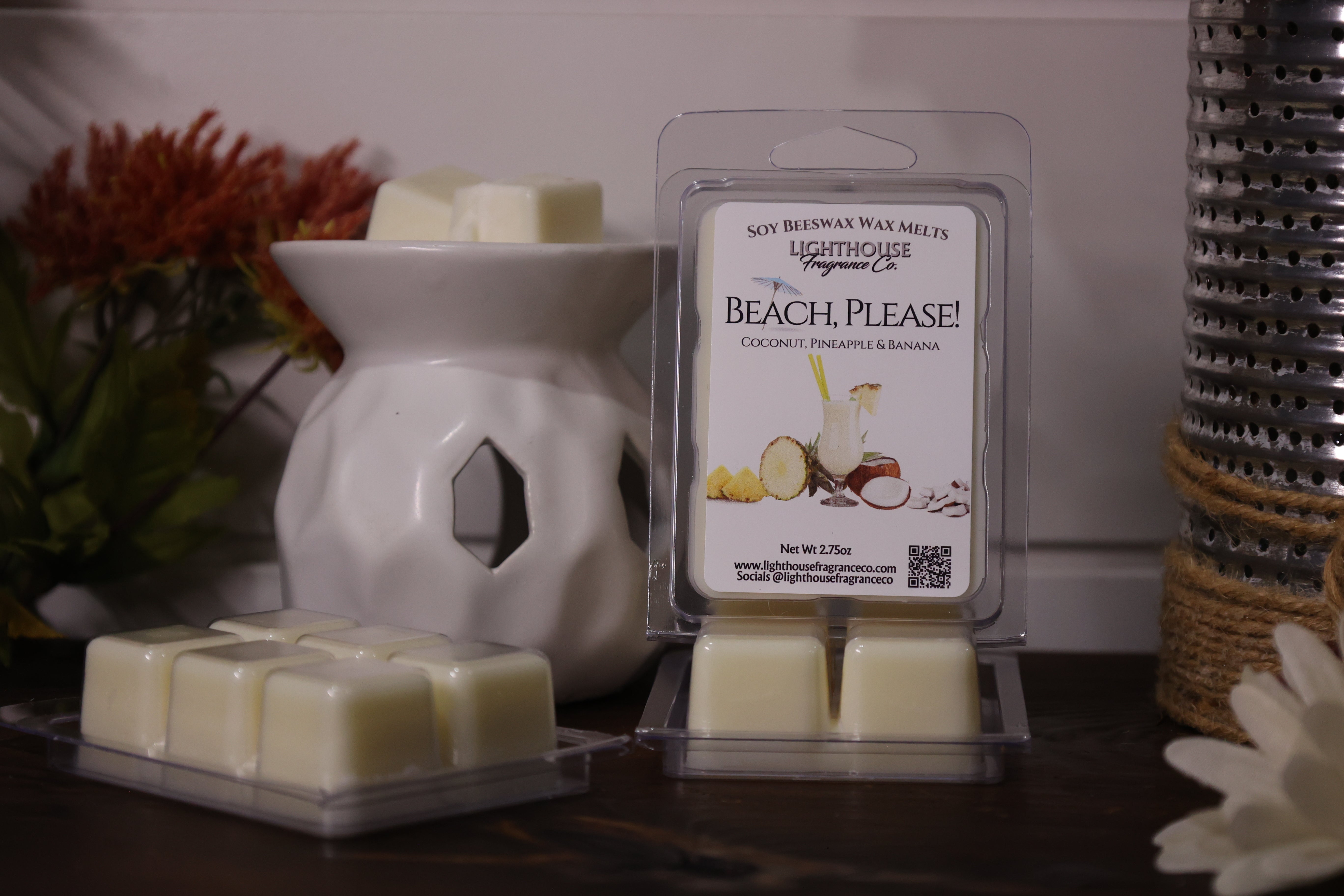 Beach-themed wax melts packaging with a wax warmer on a decorative surface.