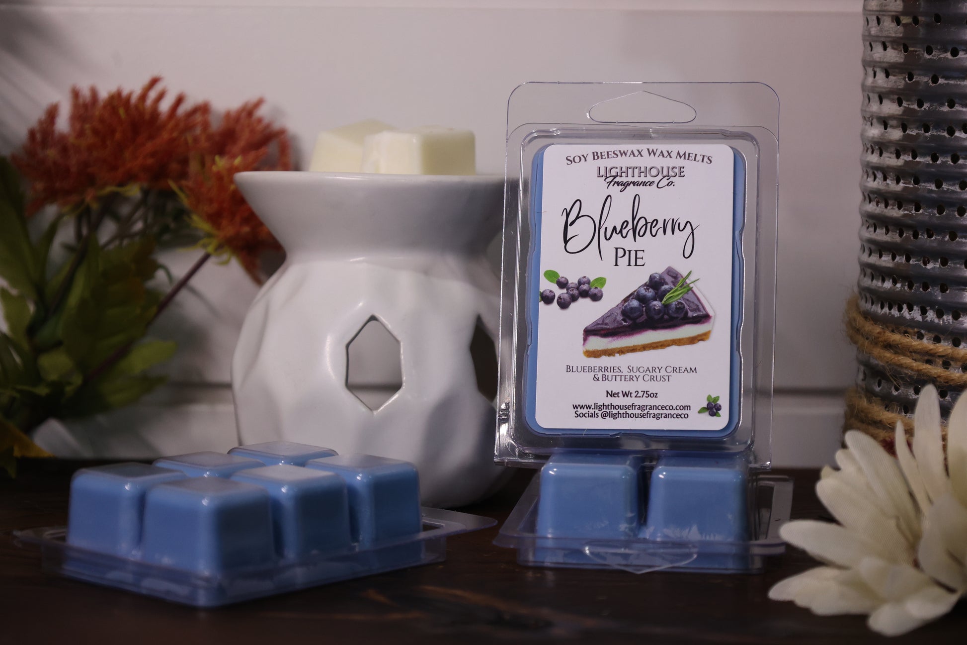 Blueberry pie scented wax melts in packaging with a white wax warmer and decorative items.