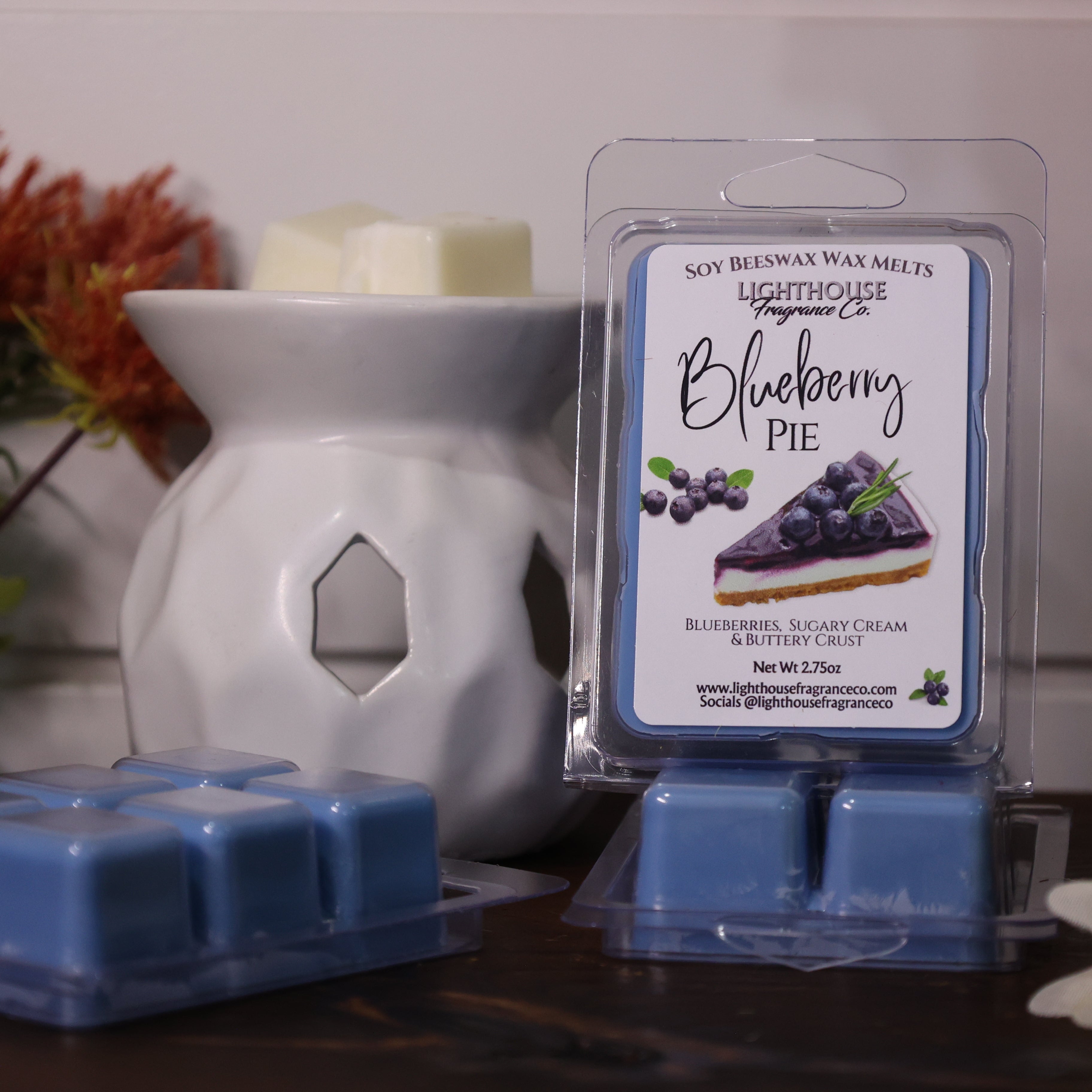 Blueberry pie scented wax melts in packaging with a white wax warmer and decorative items.
