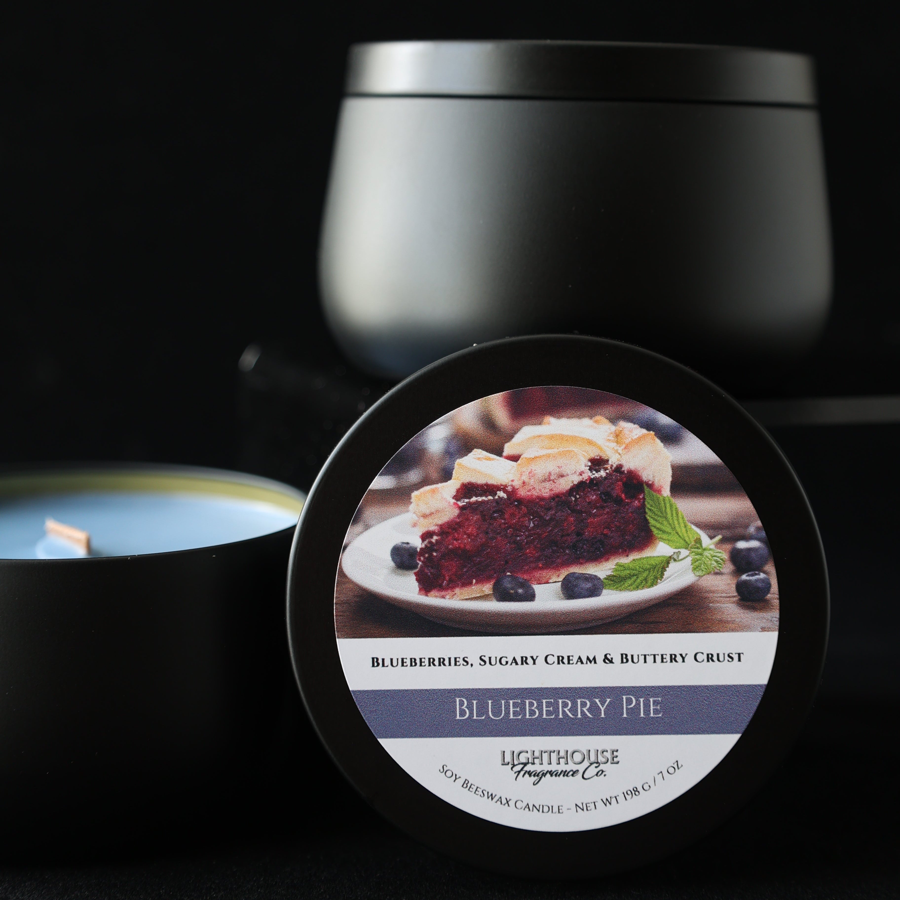 black candle tin, blue wax, candle named blueberry pie