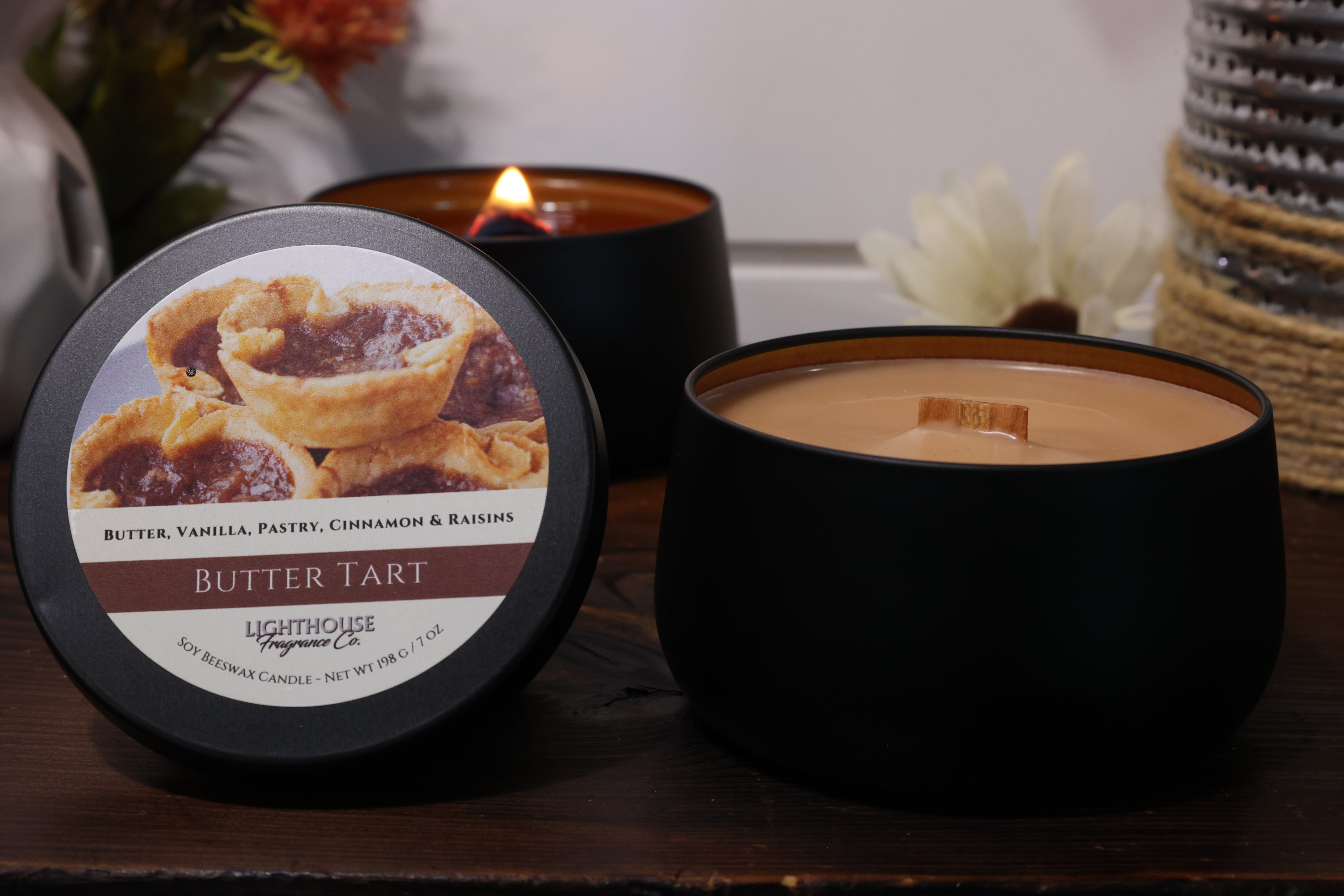 Butter tart scented candle with packaging on a wooden surface