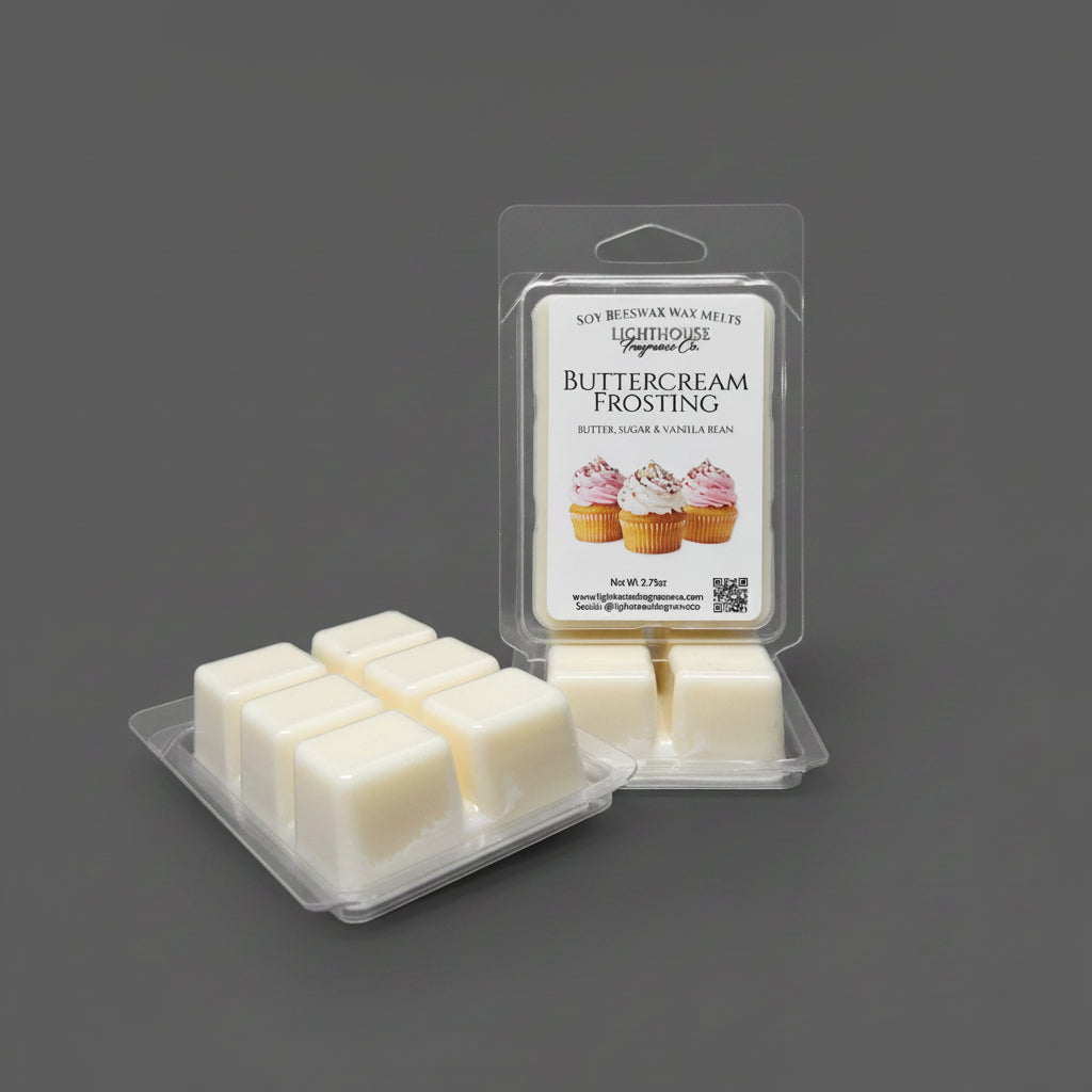 A package of wax melts labeled 'Buttercream Frosting'  shown with several cream-colored wax cubes in clear plastic compartments on a light gray surface.