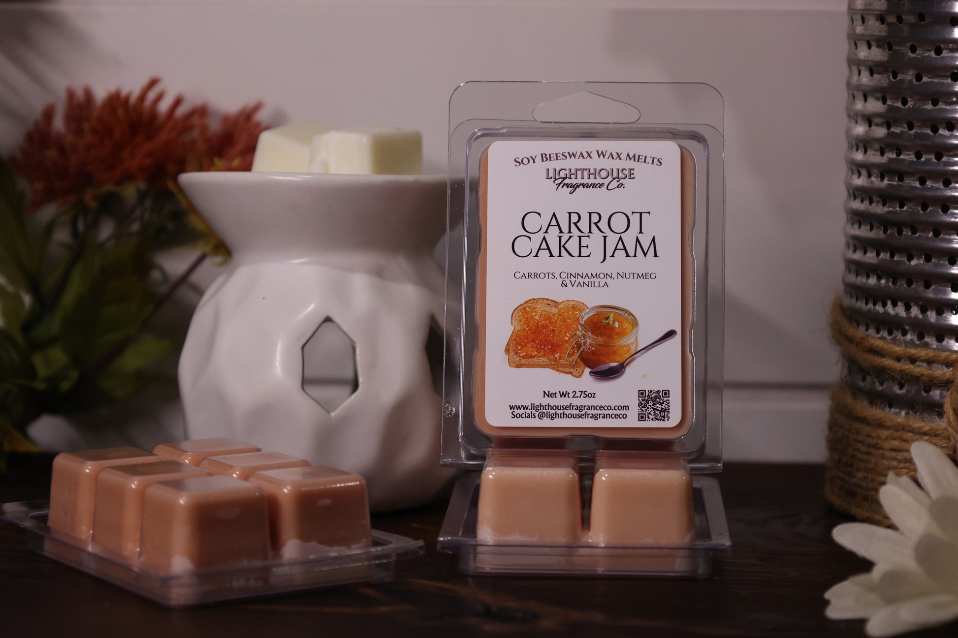 Carrot cake jam wax melts with packaging and a wax warmer on a wooden surface.