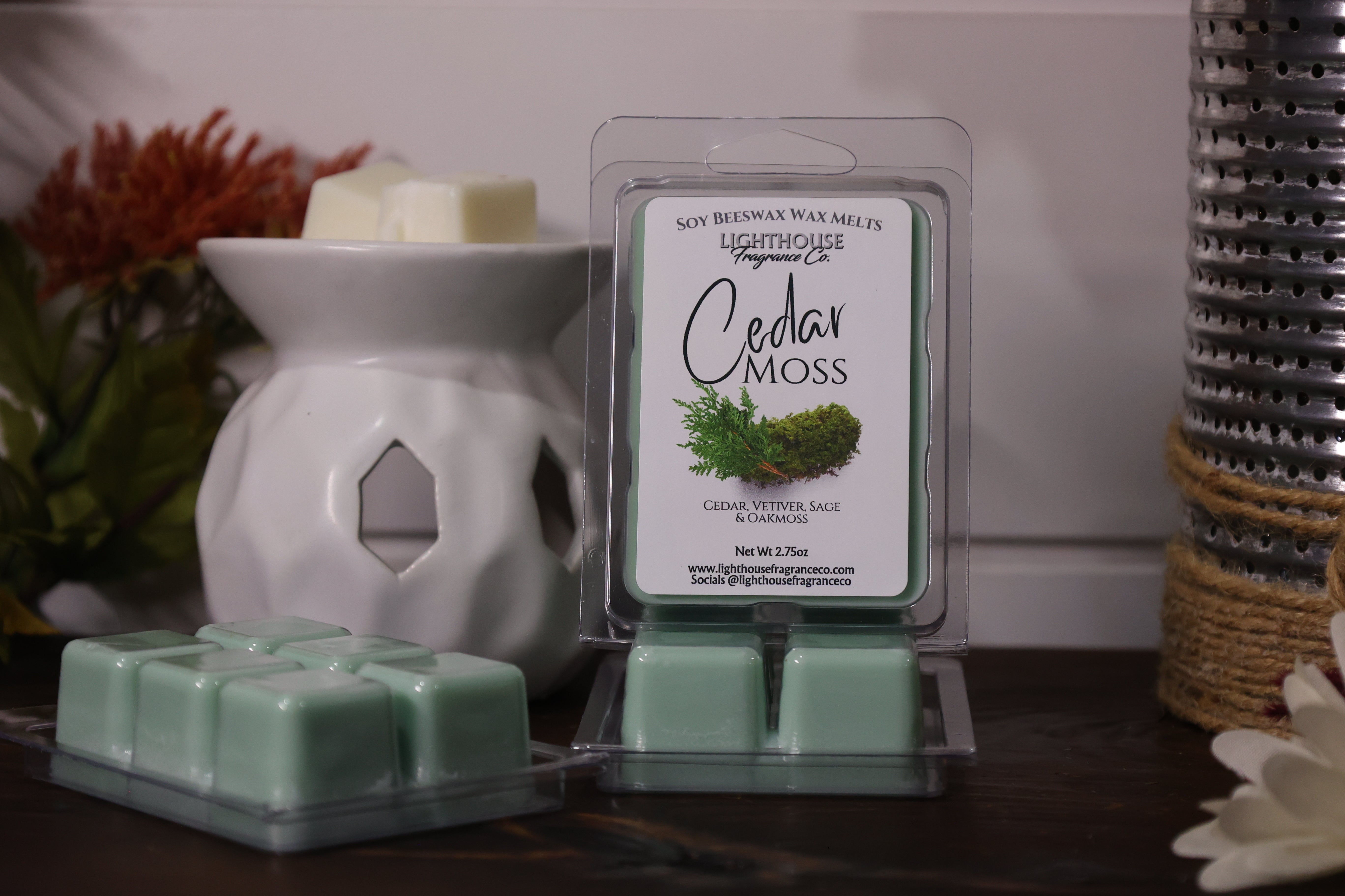 Cedar Moss wax melts with packaging and a wax warmer on a wooden surface.