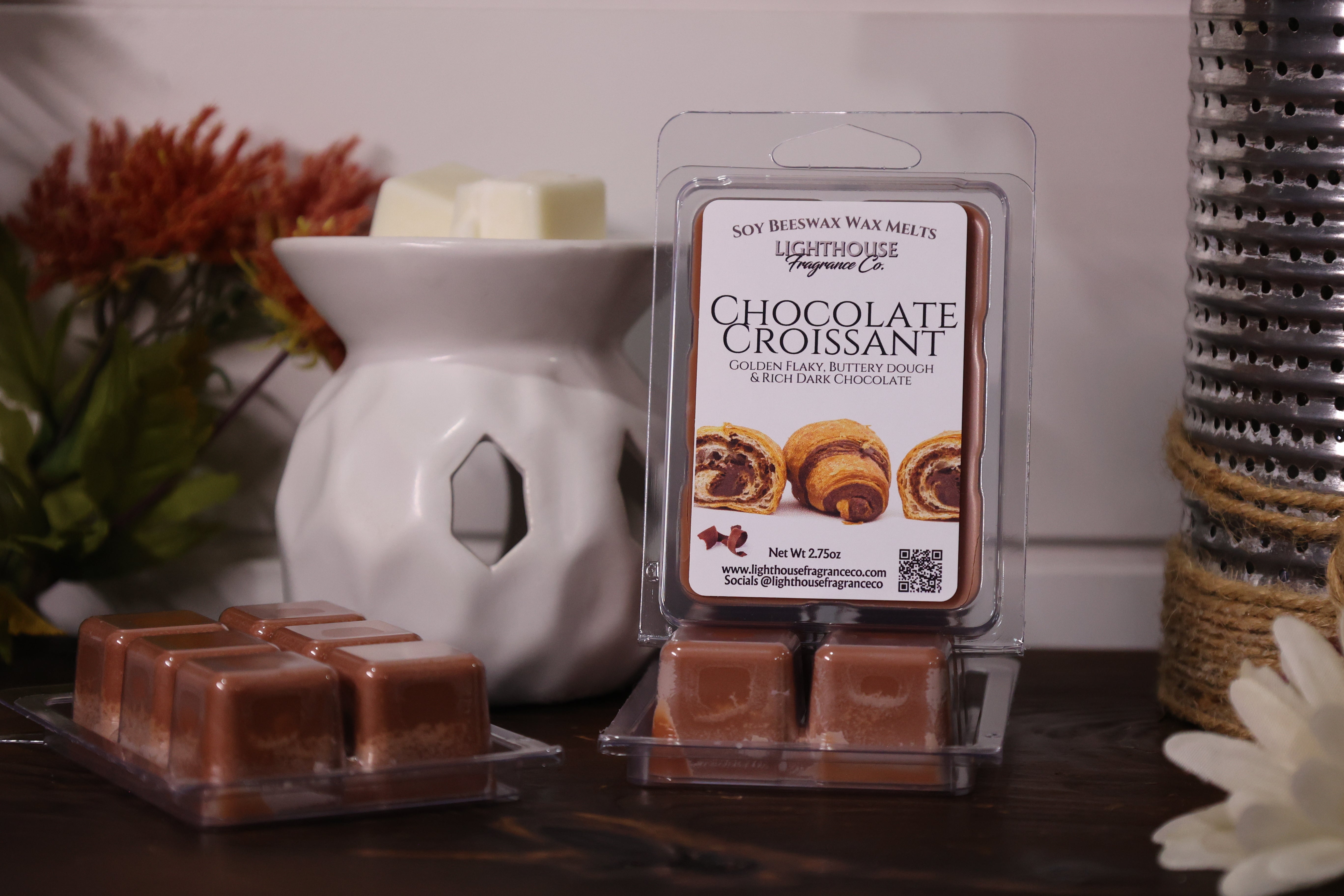 Chocolate croissant wax melts with packaging in front of a white wax warmer.