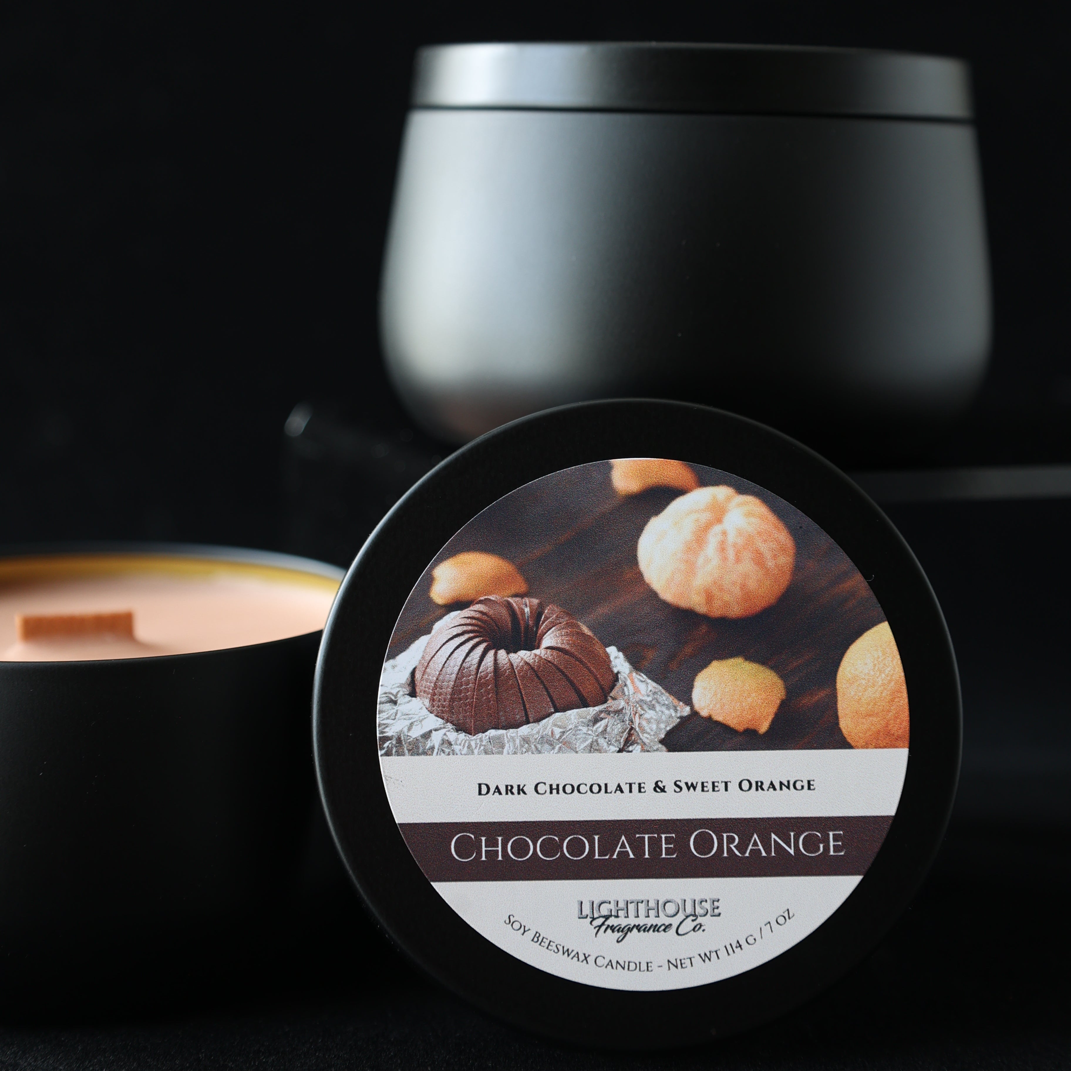 candle with a chocolate orange flavor label on a black background