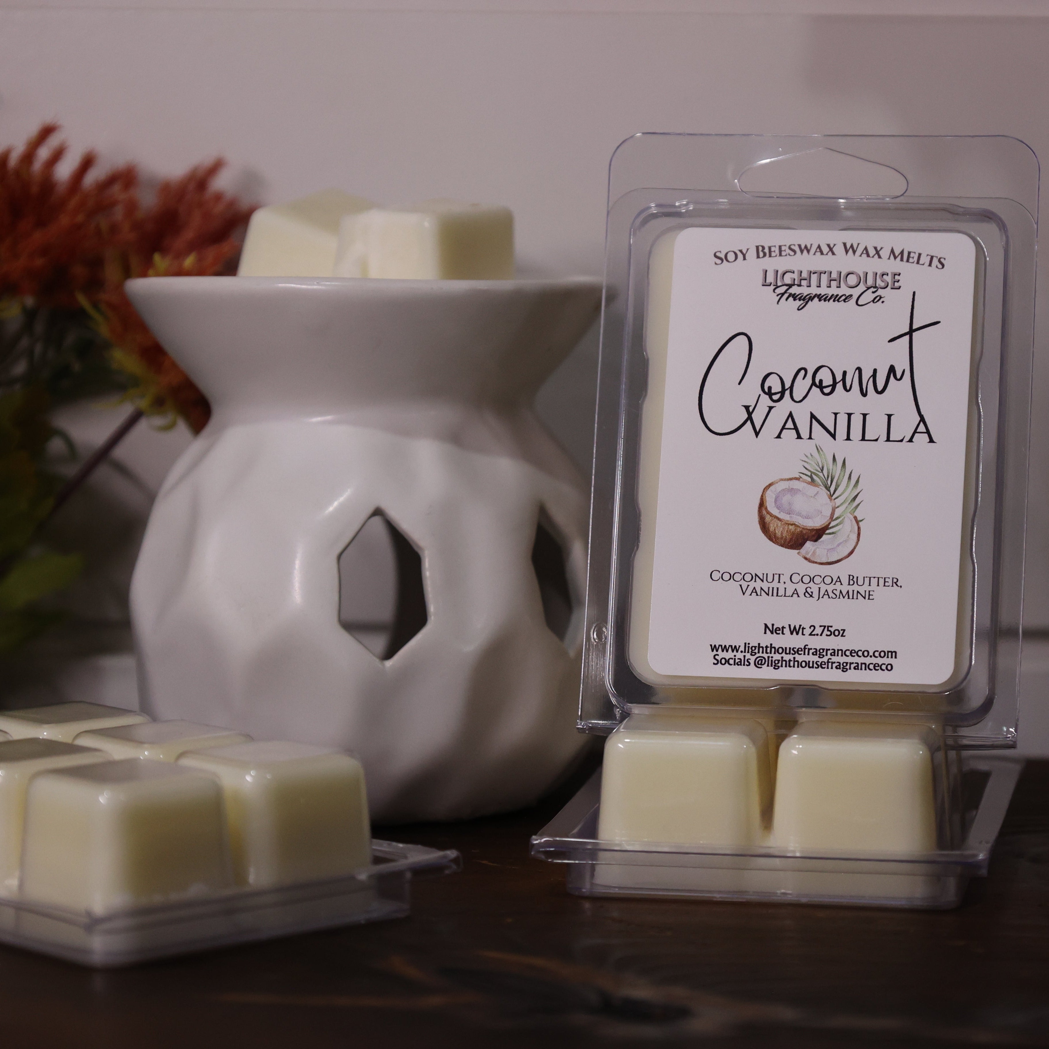 Coconut Vanilla wax melts in packaging with a white wax warmer on a wooden surface.