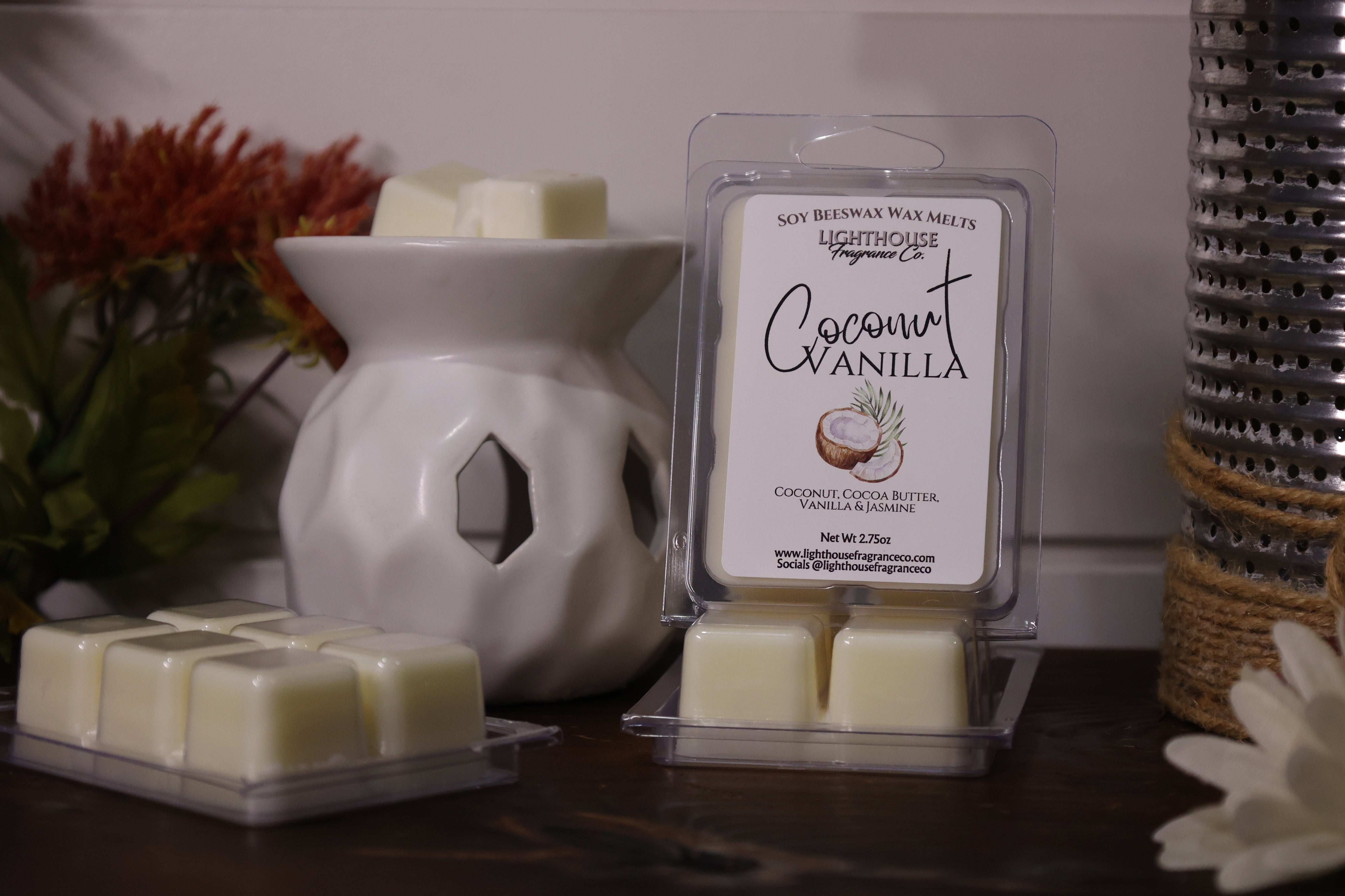 Coconut Vanilla wax melts in packaging with a white wax warmer on a wooden surface.