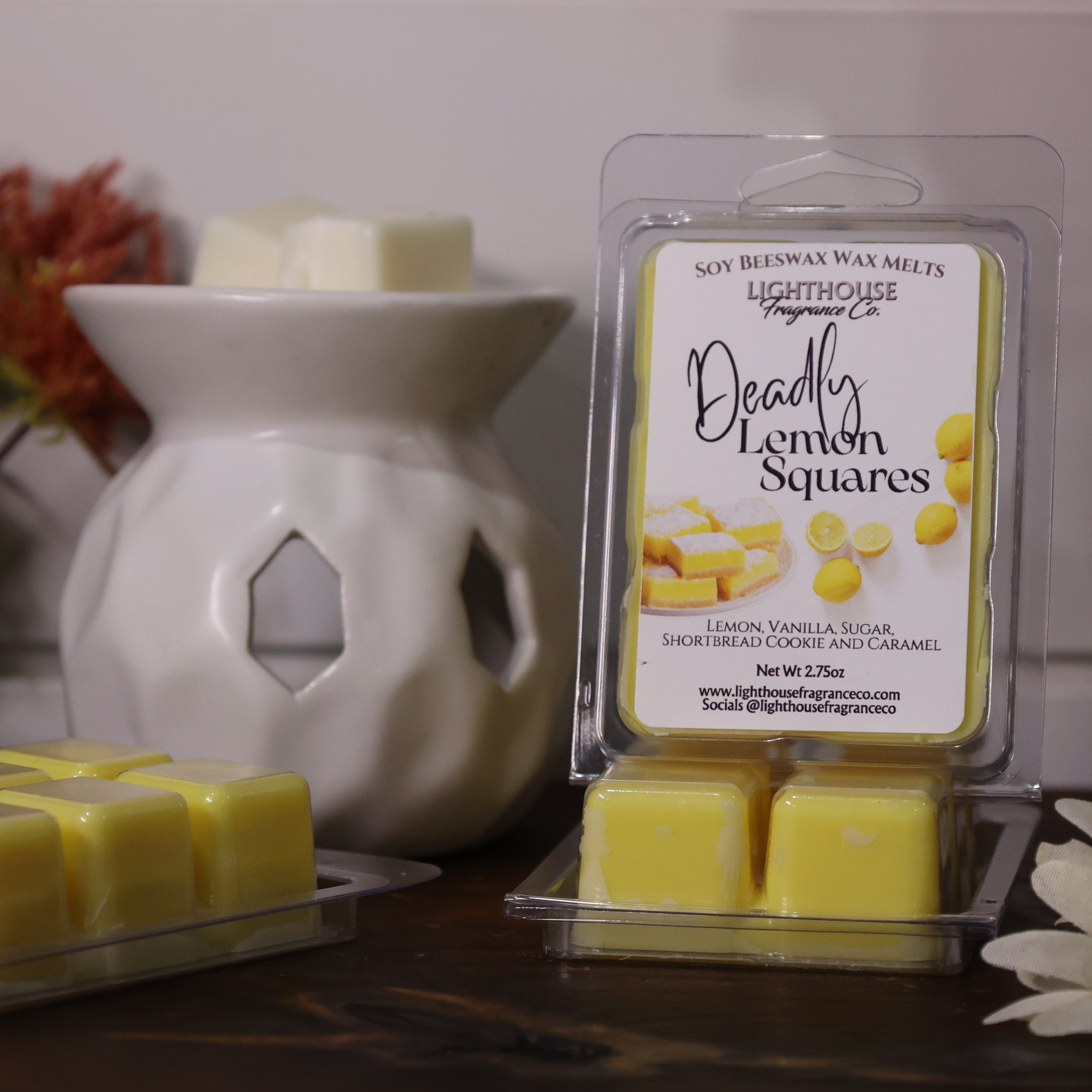 Packaged lemon wax melts with a diffuser and decorative items on a surface.