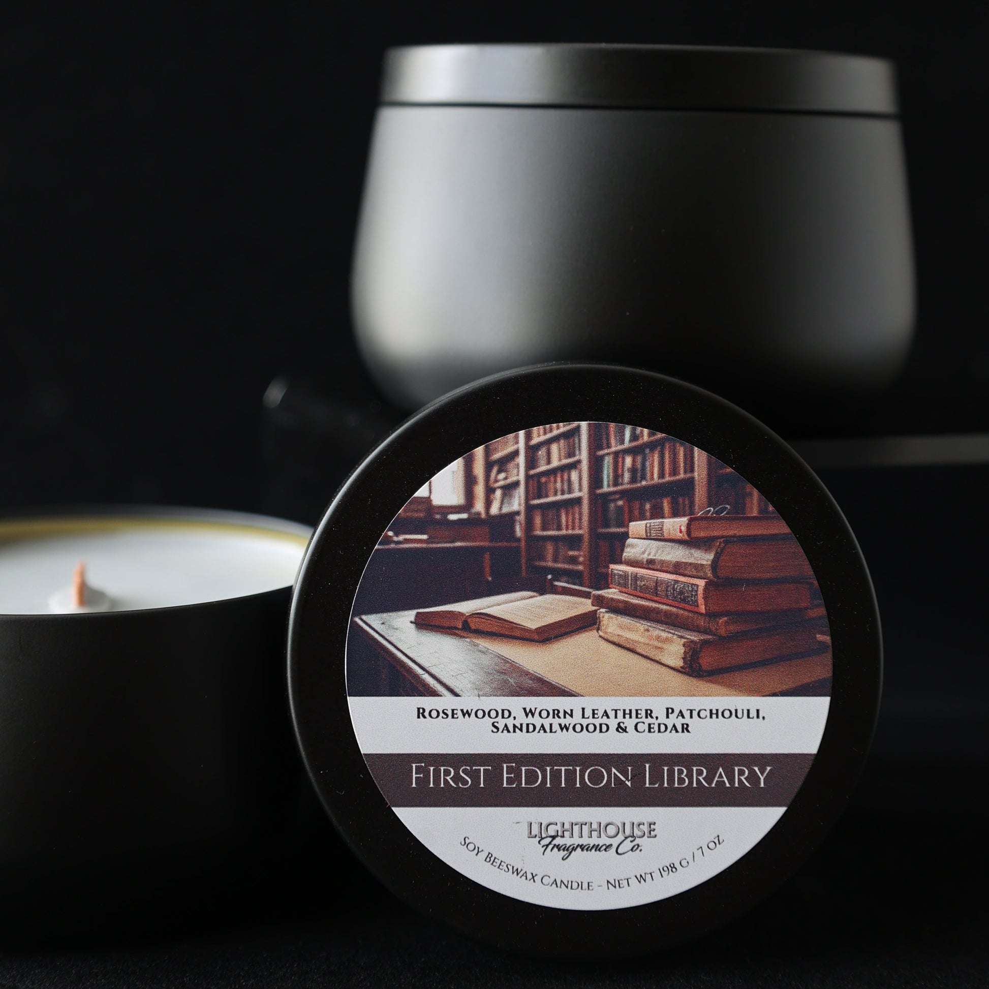 First Edition Library Candle in a black tin against a black background
