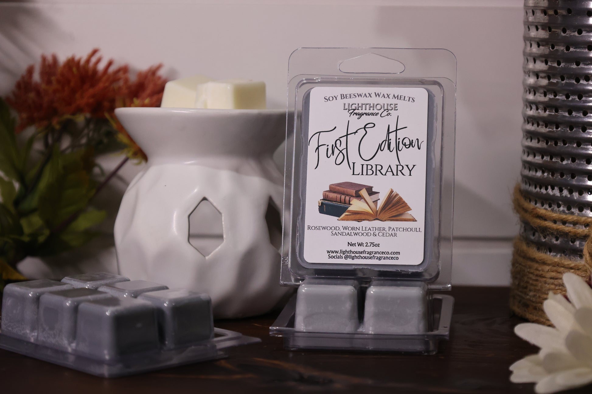 Packaged wax melts with a diffuser on a wooden surface
