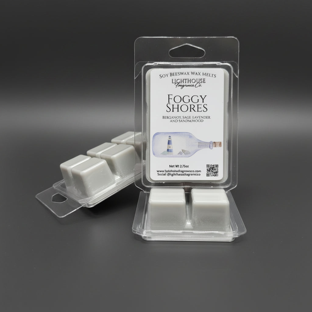 Wax melts in packaging labeled 'Foggy Shores' on a gray surface.  Newfoundland Collection scent inspired by the Island