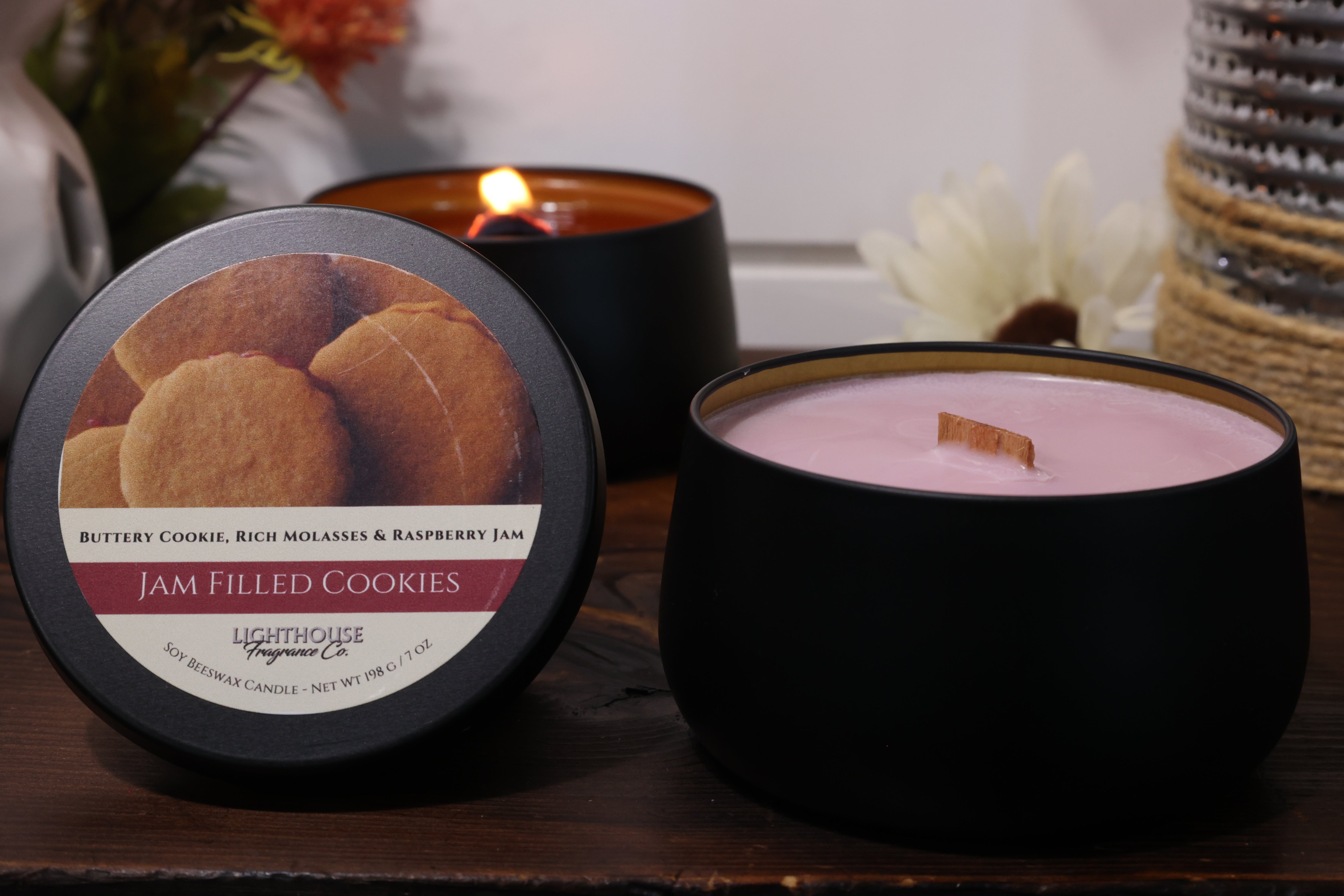 Candle with a cookie-themed label on a wooden surface