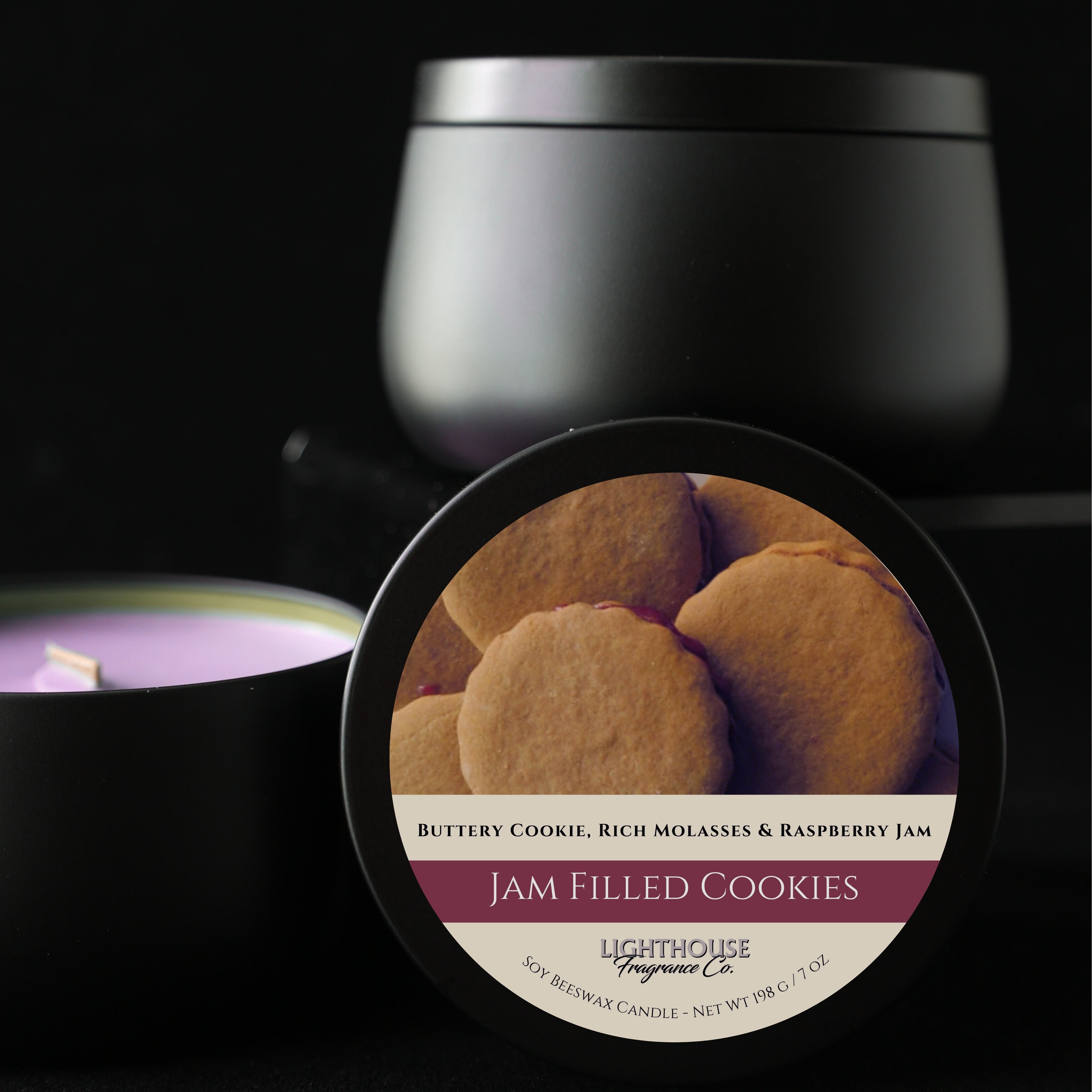 Black candle container with 'Jam Filled Cookies' label and a candle in the background.