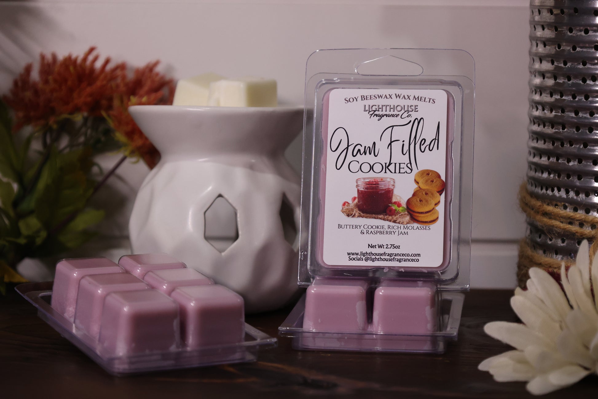 Jam filled cookies wax melts in packaging with decorative elements on a wooden surface.