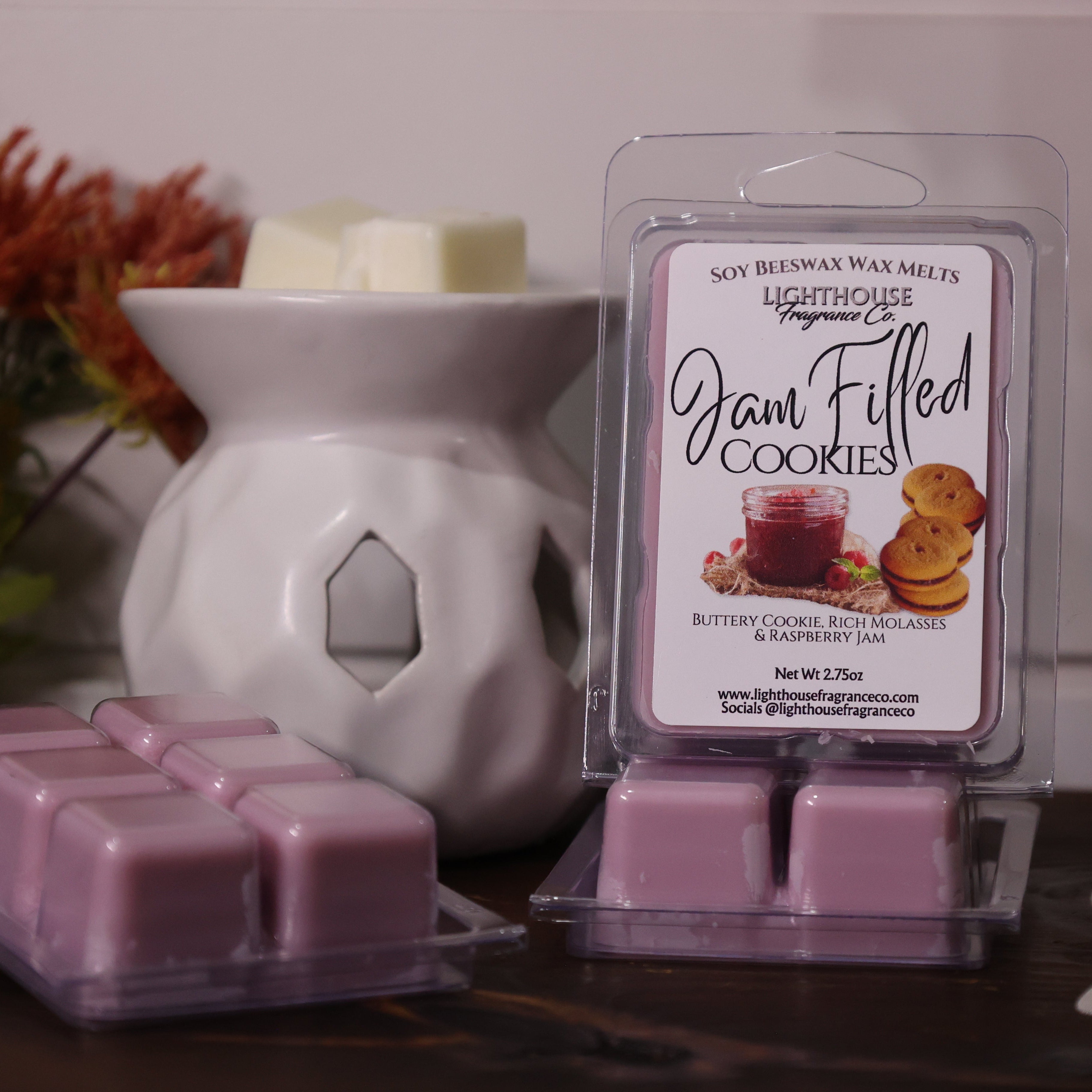 Jam filled cookies wax melts in packaging with decorative elements on a wooden surface.