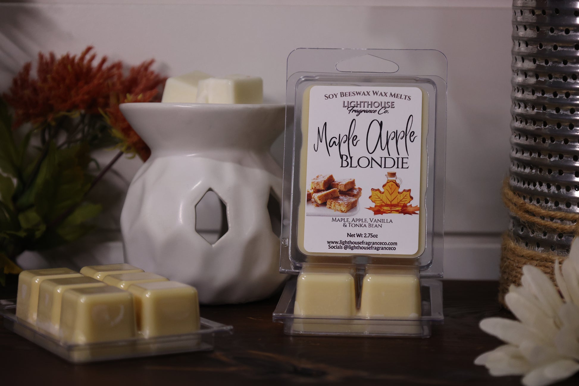Lighthouse Maple Apple Blondie wax melts with a white wax warmer on a wooden surface.