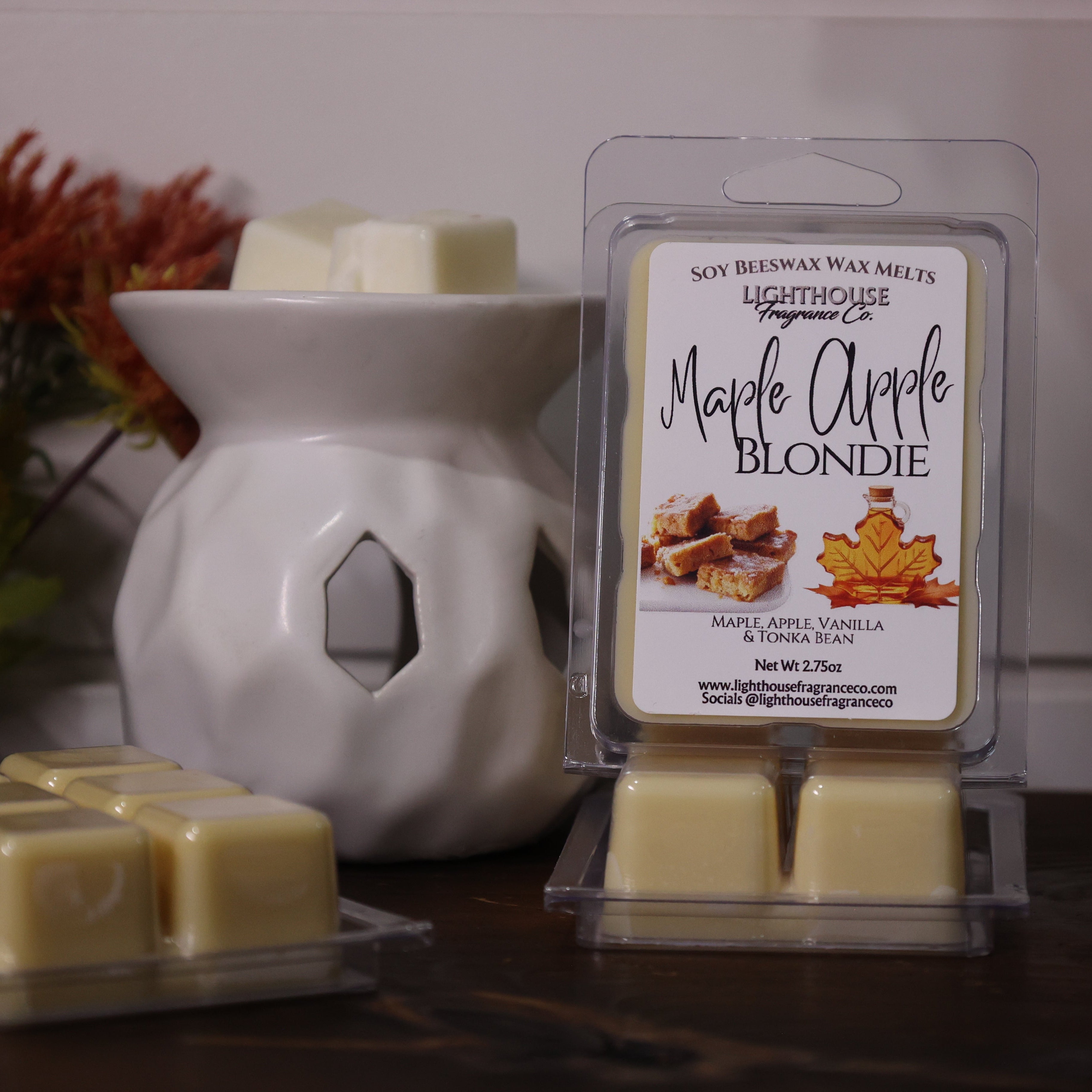 Lighthouse Maple Apple Blondie wax melts with a white wax warmer on a wooden surface.