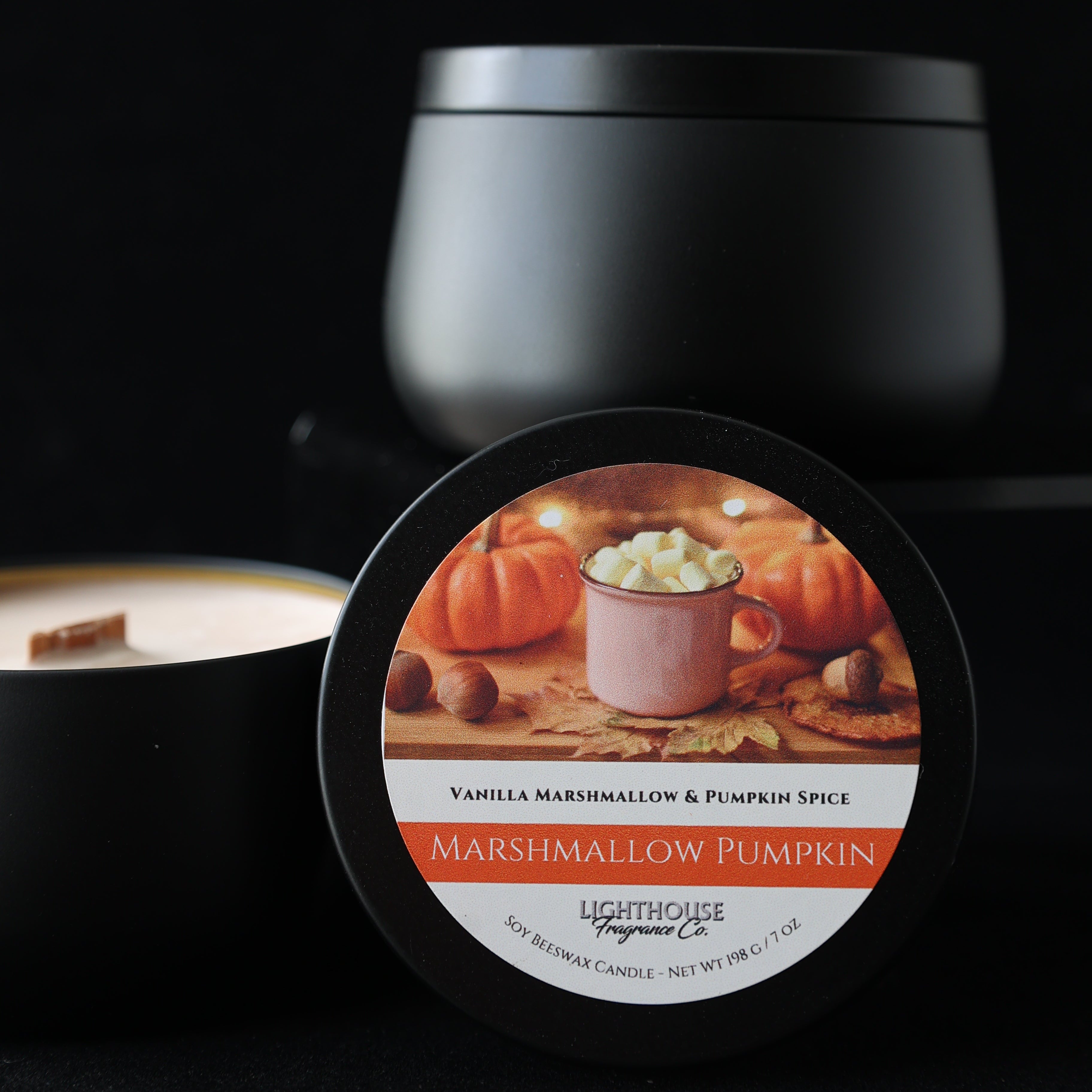Marshmallow Pumpkin Candle in a black tin against a black background