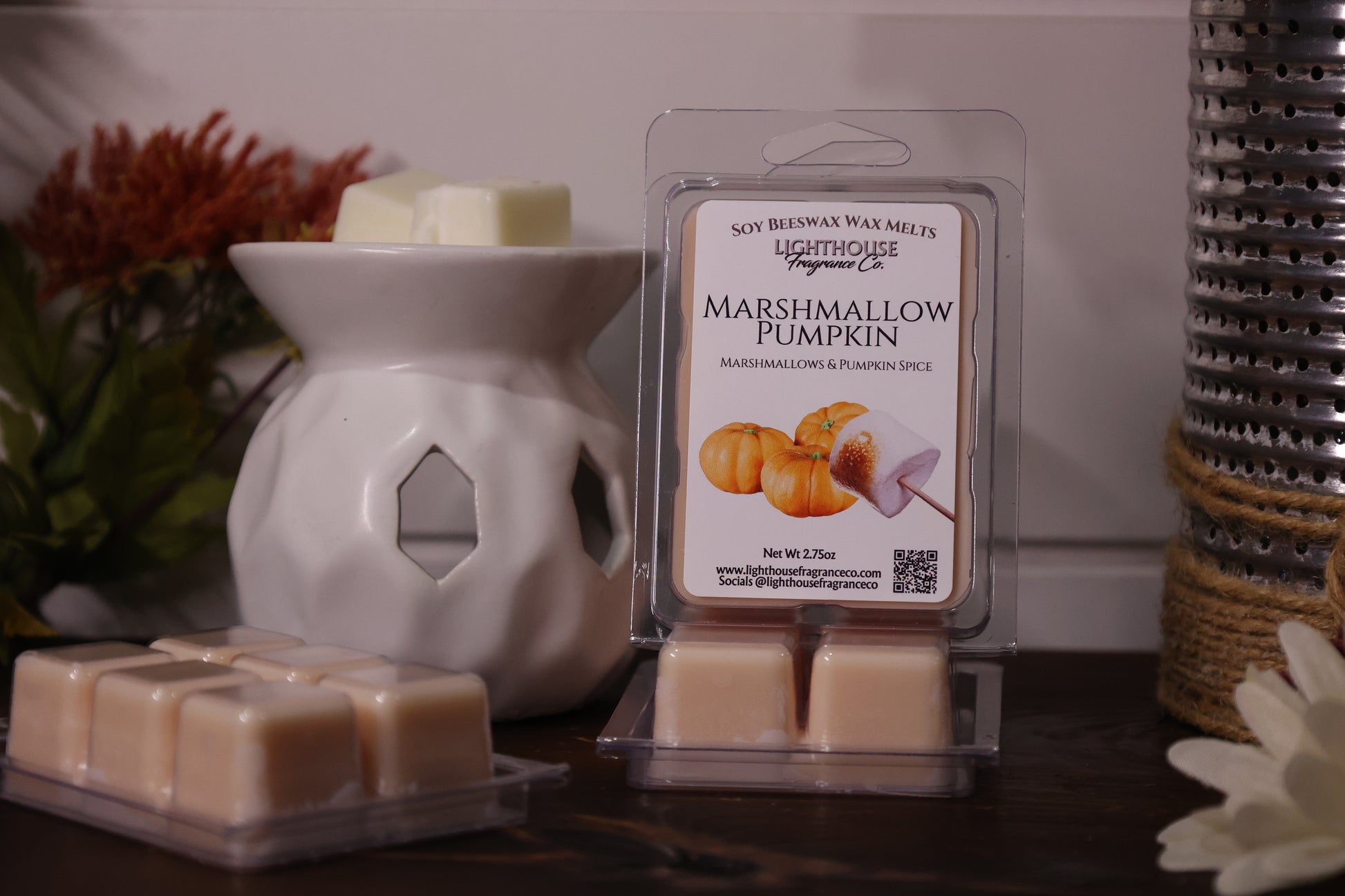 Marshmallow Pumpkin wax melt packaging with a white wax warmer on a decorative background