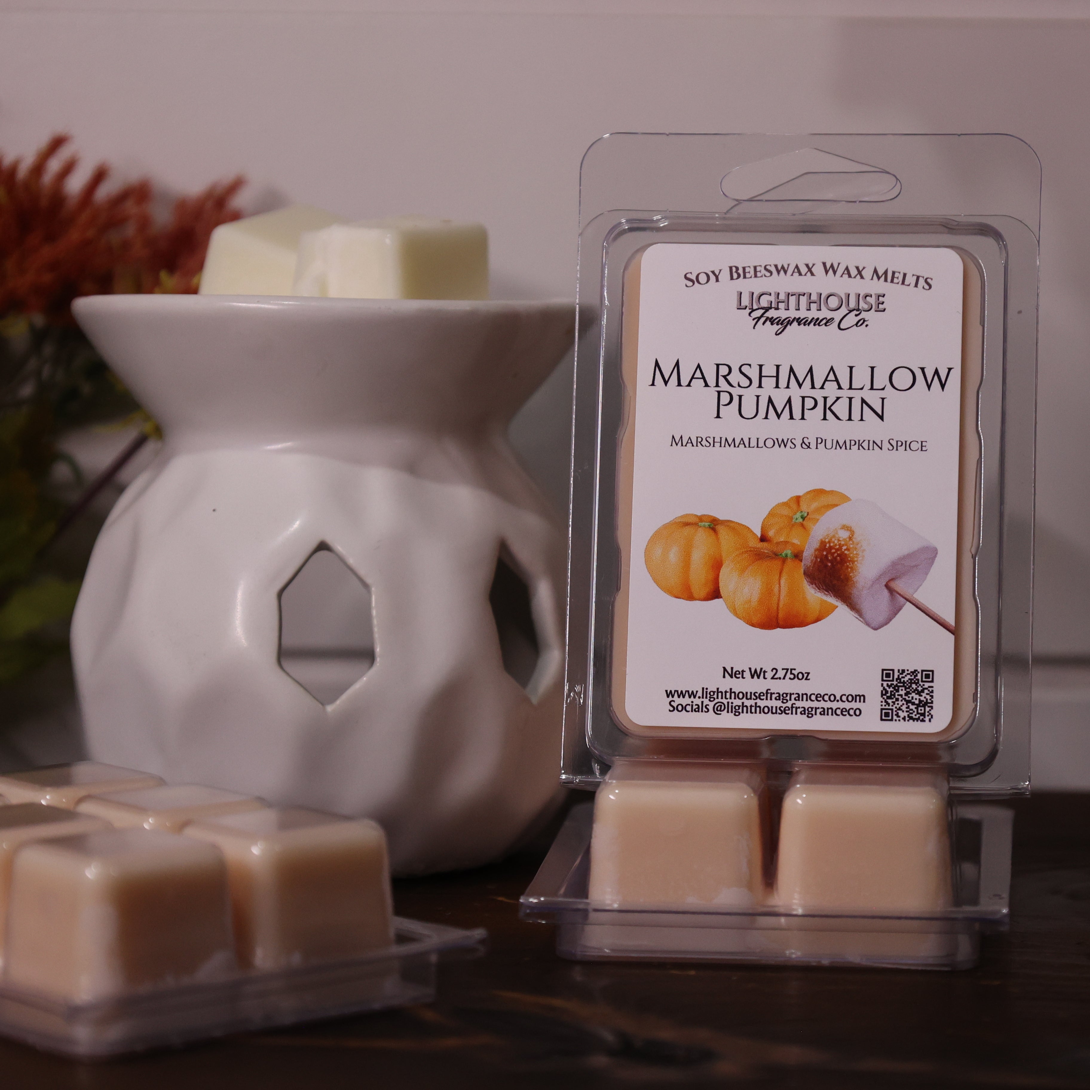 Marshmallow Pumpkin wax melt packaging with a white wax warmer on a decorative background
