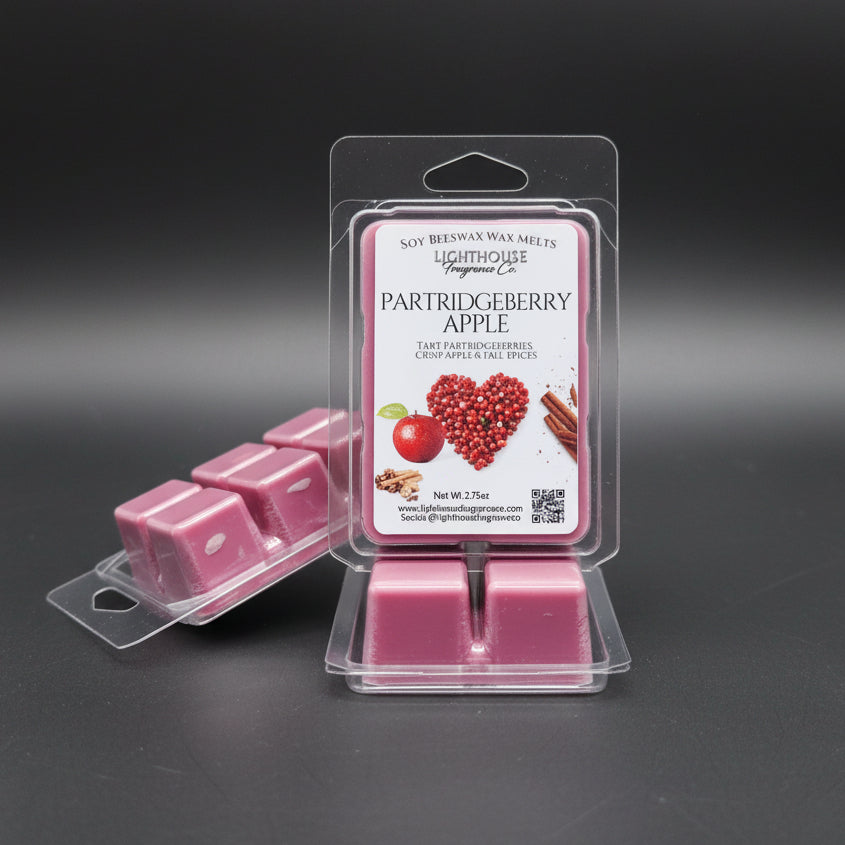 Partridgeberry Apple wax melts in packaging with a label on a gray surface