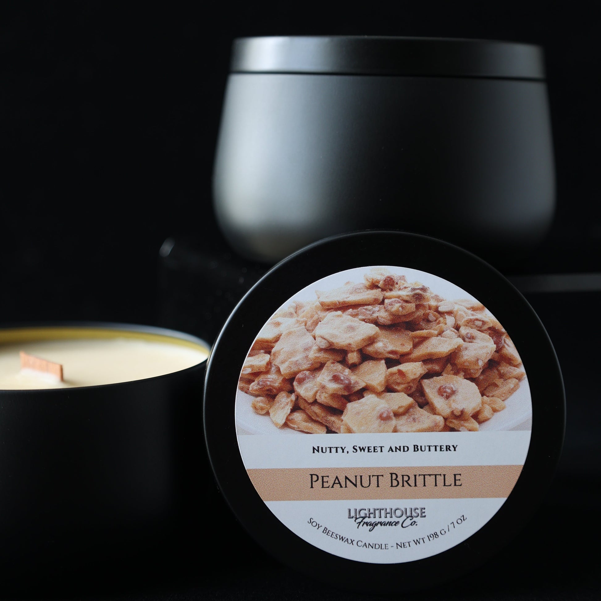 Peanut brittle candle container with a label on a black background