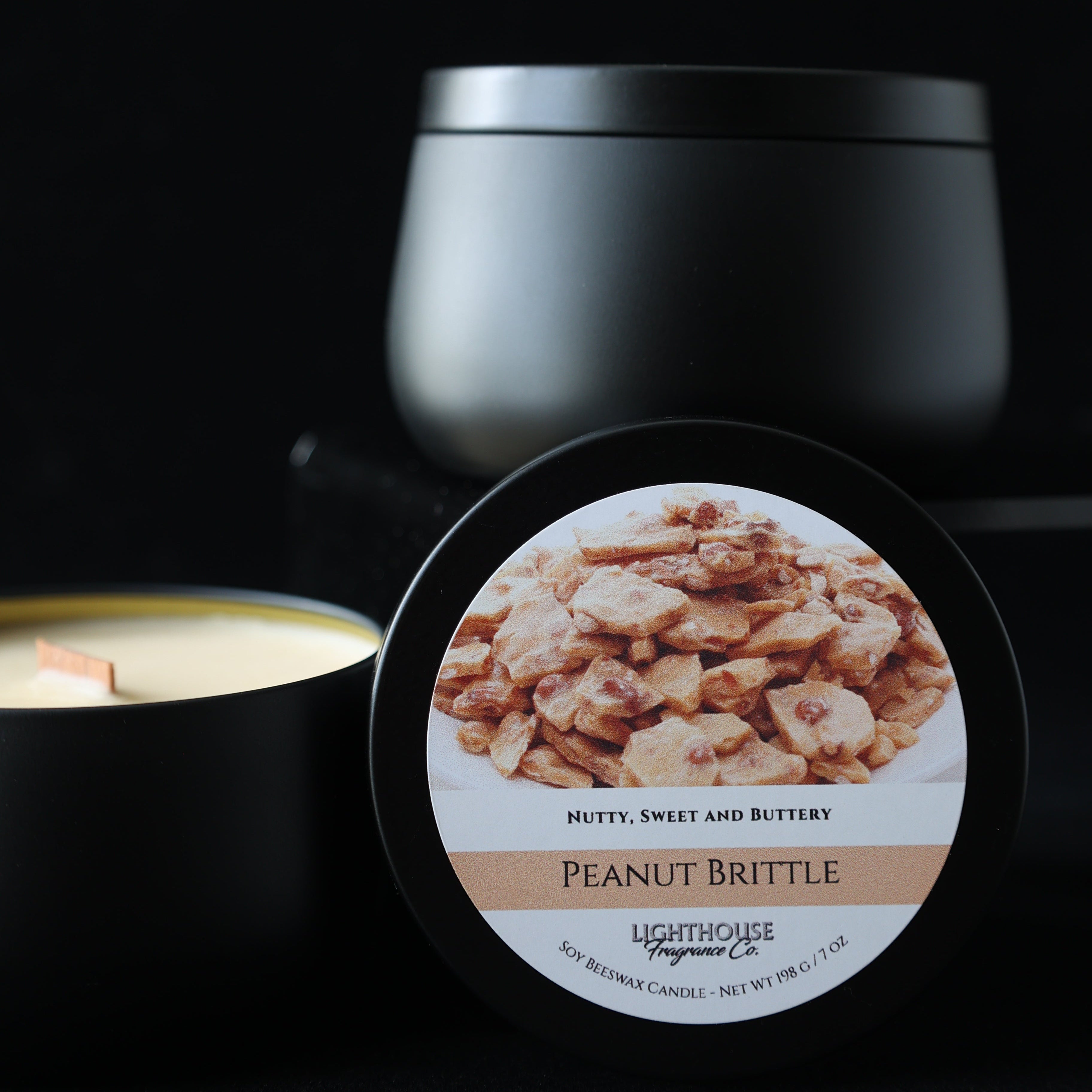 Peanut brittle candle container with a label on a black background