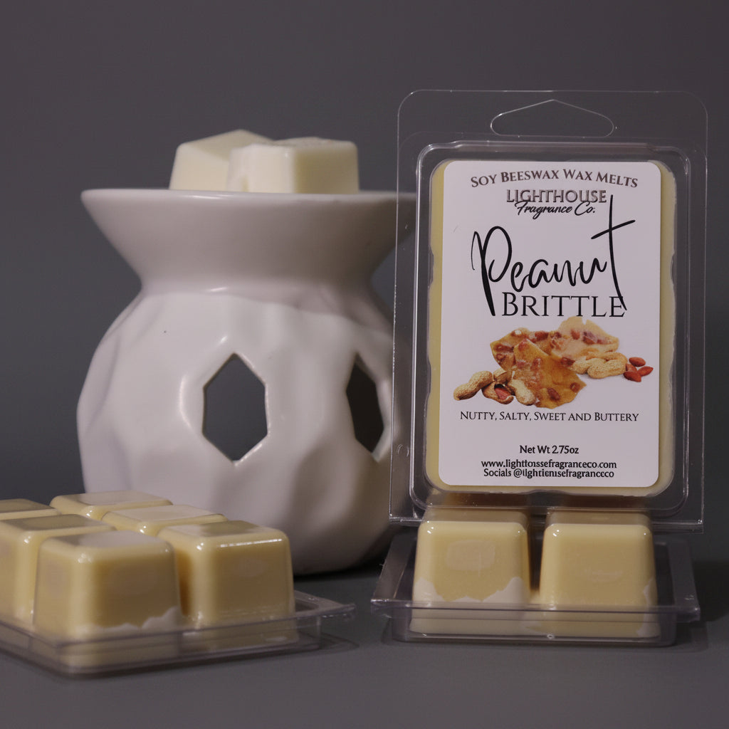 Soy wax melts with a packaging labeled 'Peanut Brittle' next to a wax warmer on a wooden surface.
