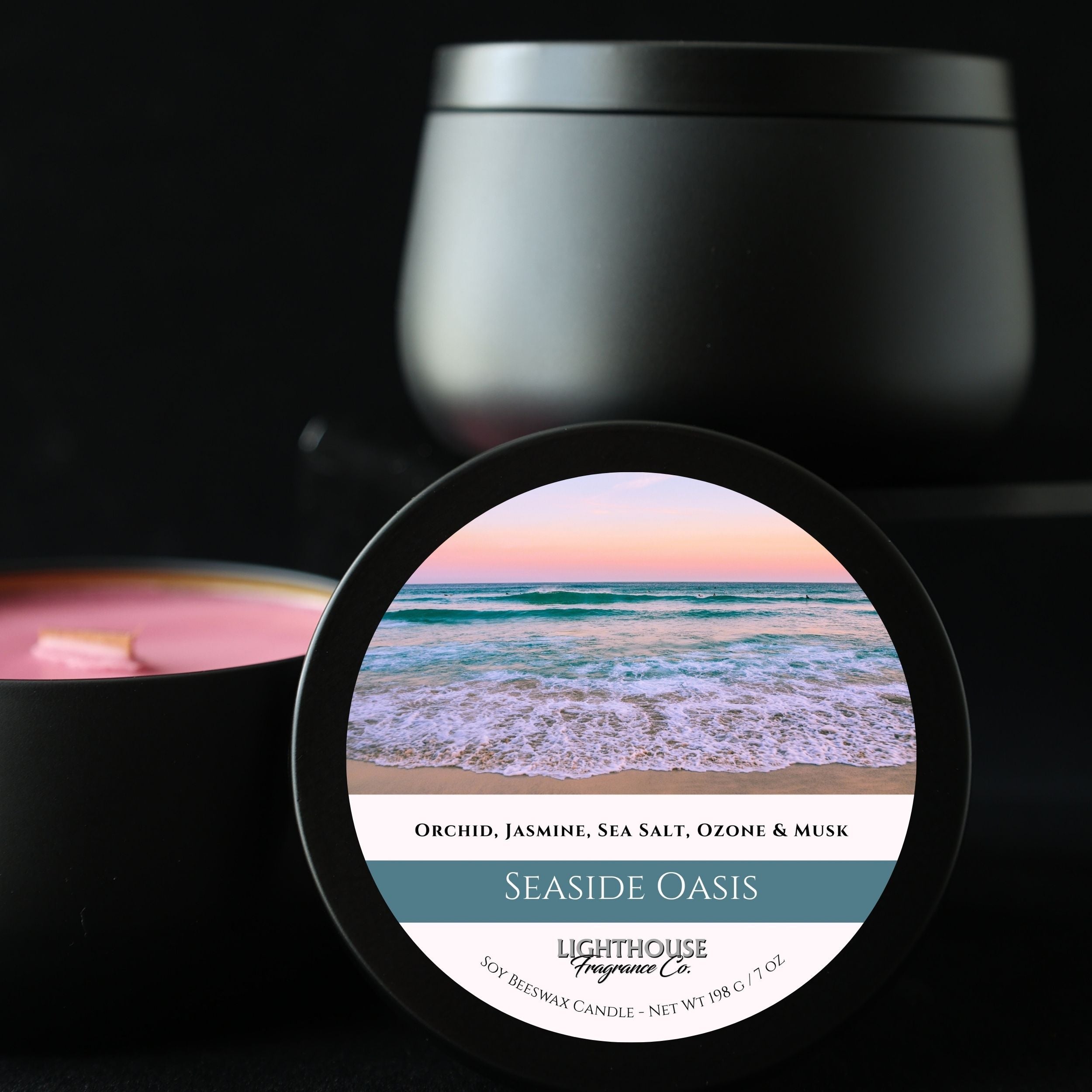 Black candle jar with a label featuring a beach scene and product details.