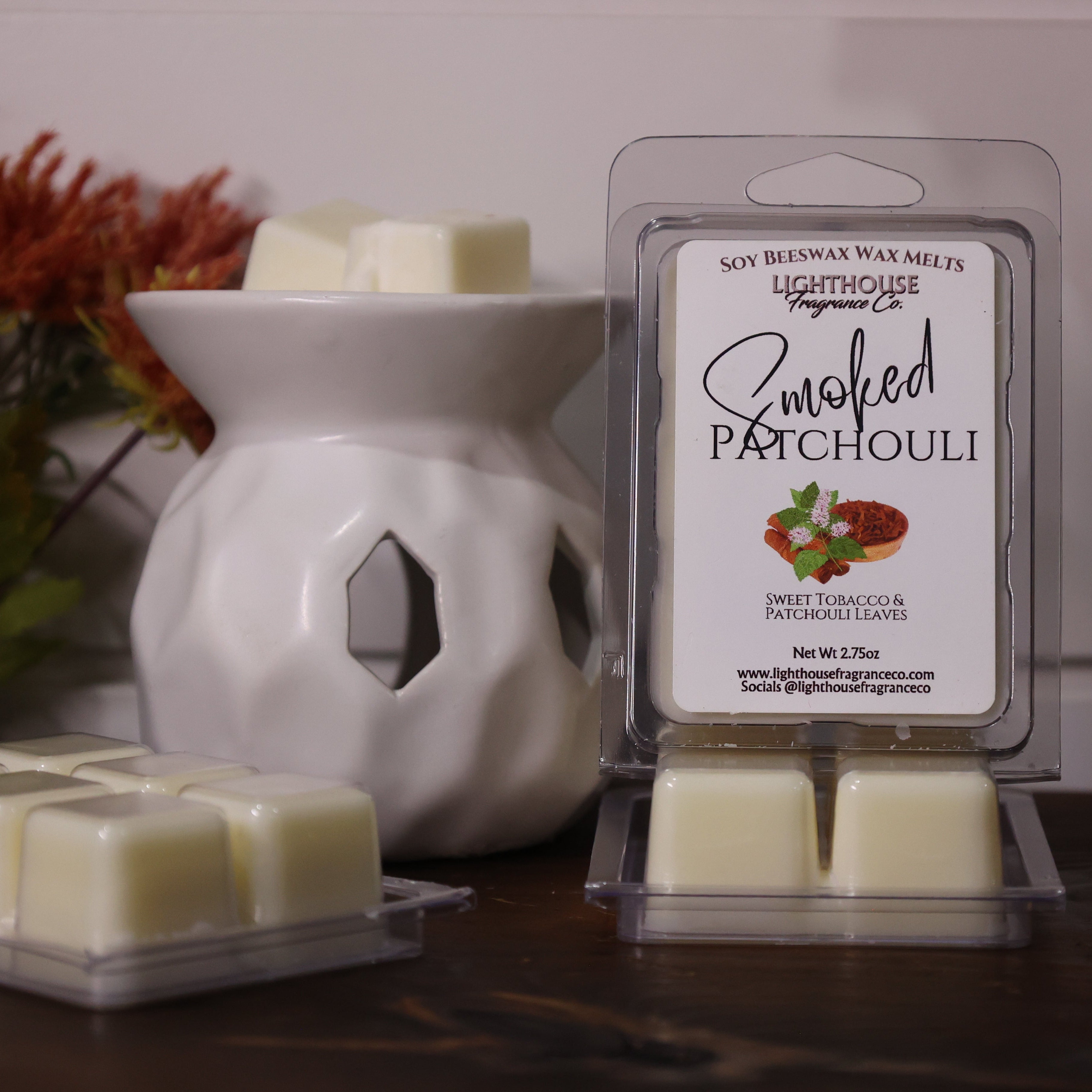 Wax melts packaging with a white wax melt burner and decorative elements.