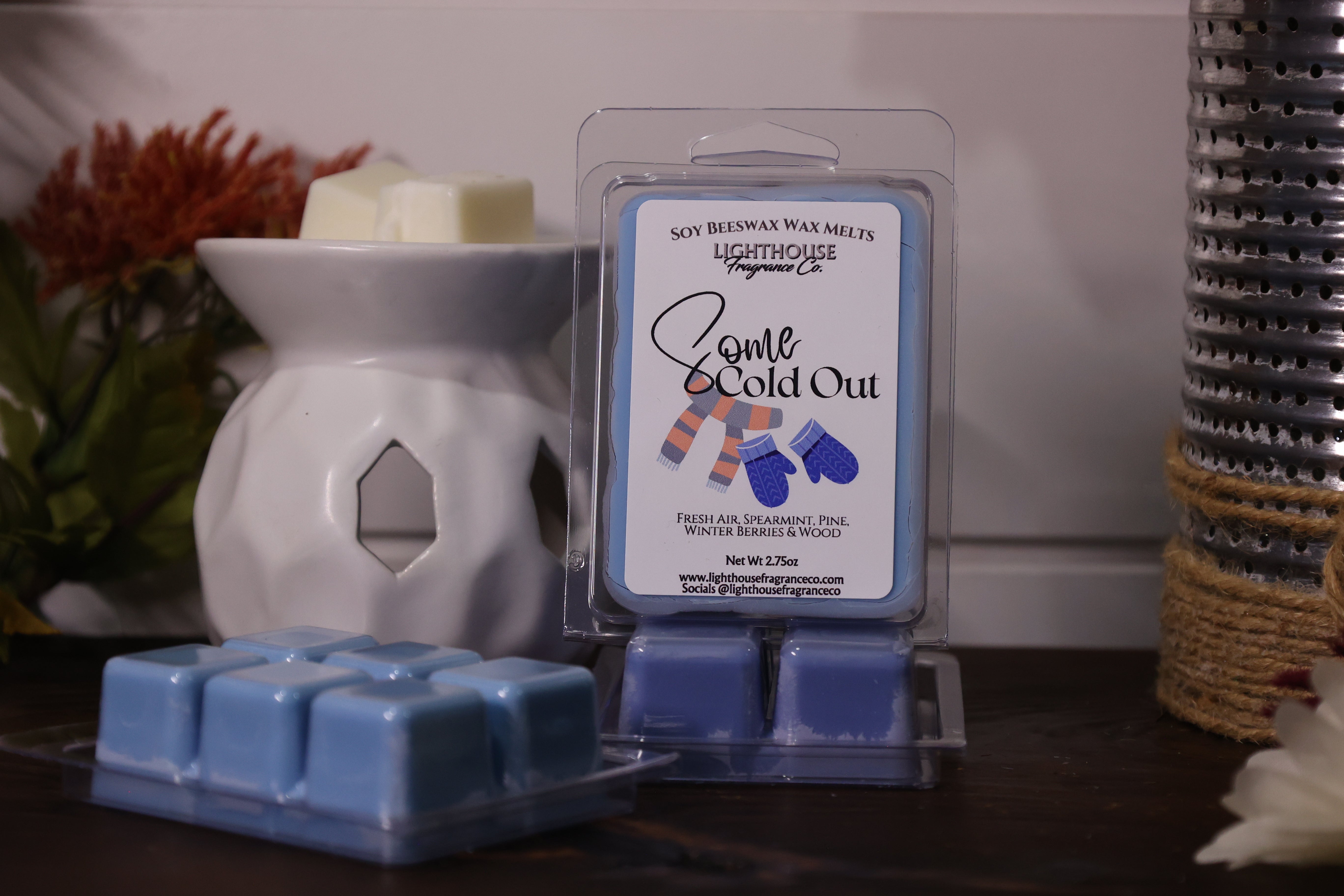 Soy wax melts packaging with a wax melter on a wooden surface.