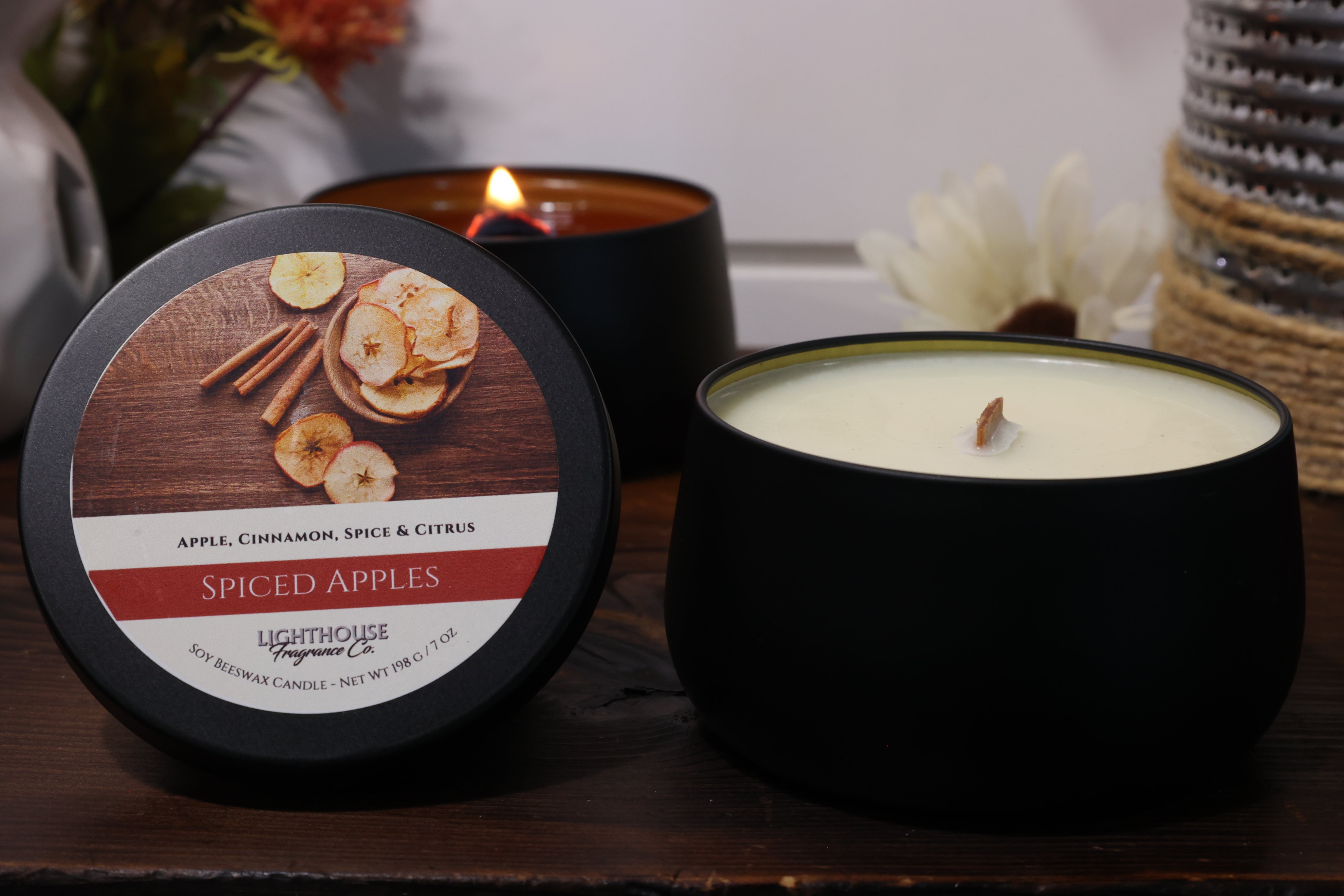 Spiced Apples candle with packaging on a wooden surface