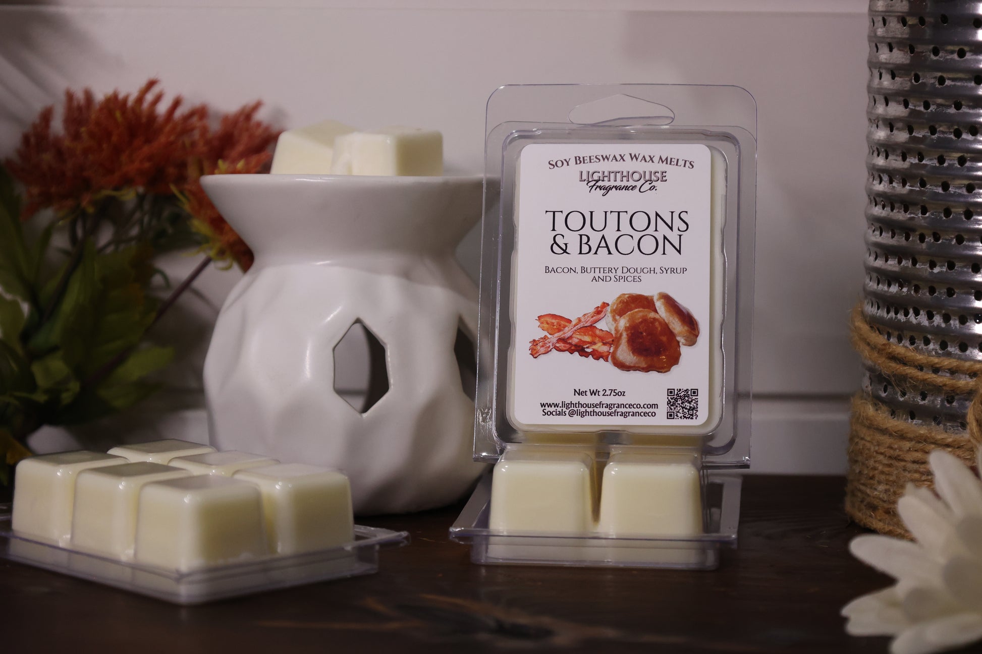 Toutons & Bacon wax melts packaging with a white wax melt burner on a wooden surface.