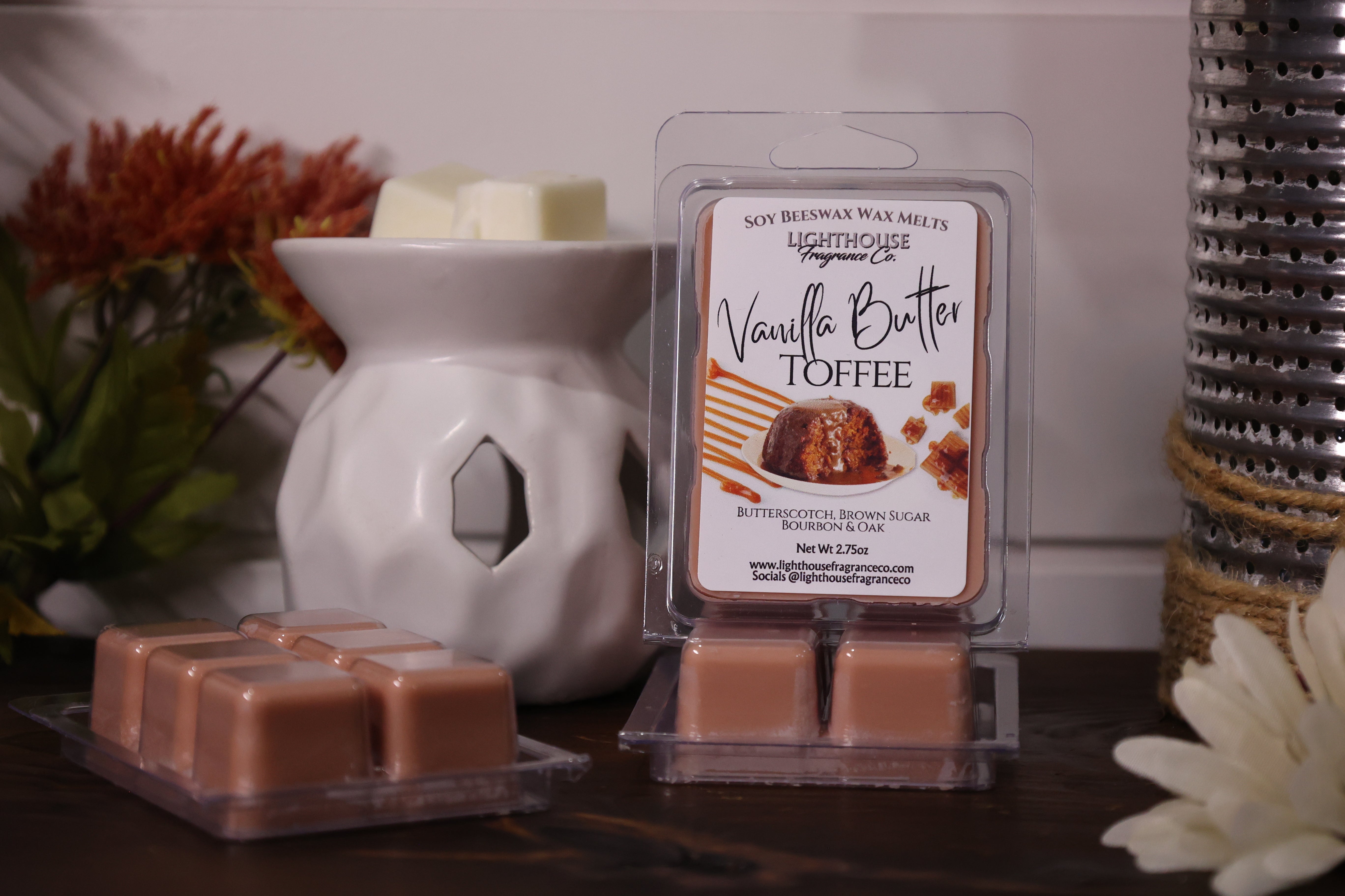 Vanilla Butter Toffee wax melts in packaging with a white wax warmer on a wooden surface.