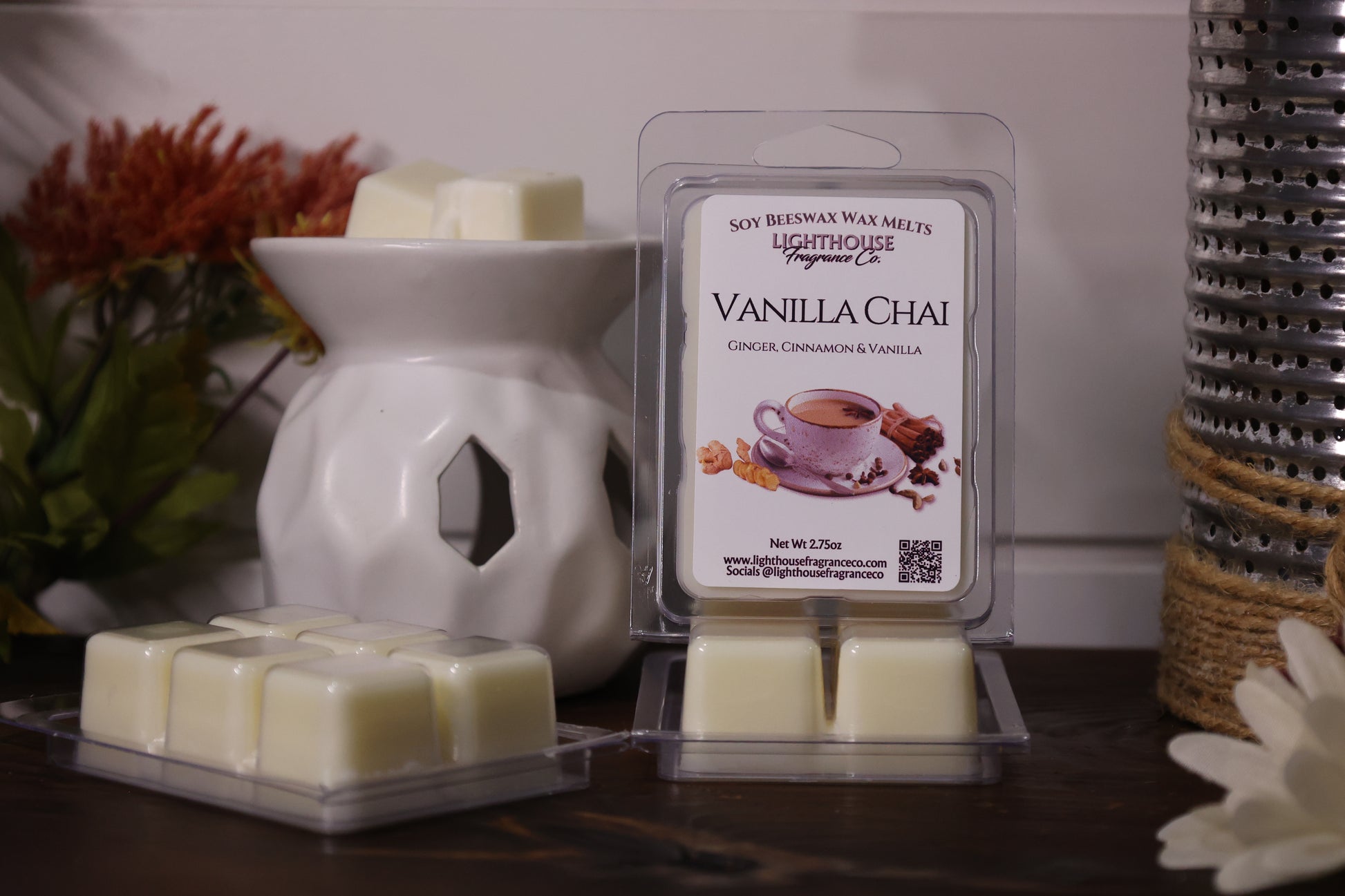 Vanilla Chai wax melt packaging with a white wax warmer on a wooden surface.
