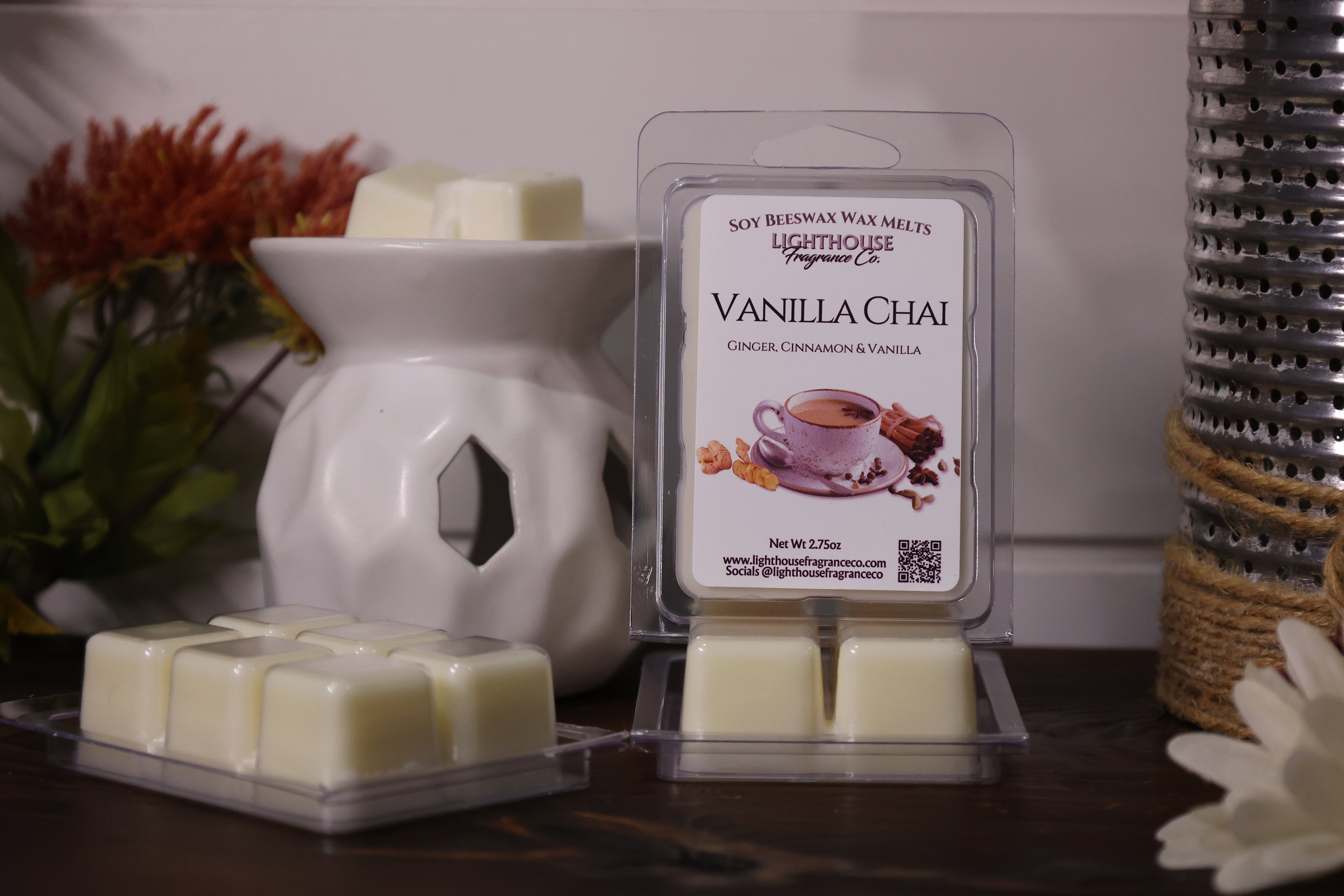 Vanilla Chai wax melt packaging with a white wax warmer on a wooden surface.