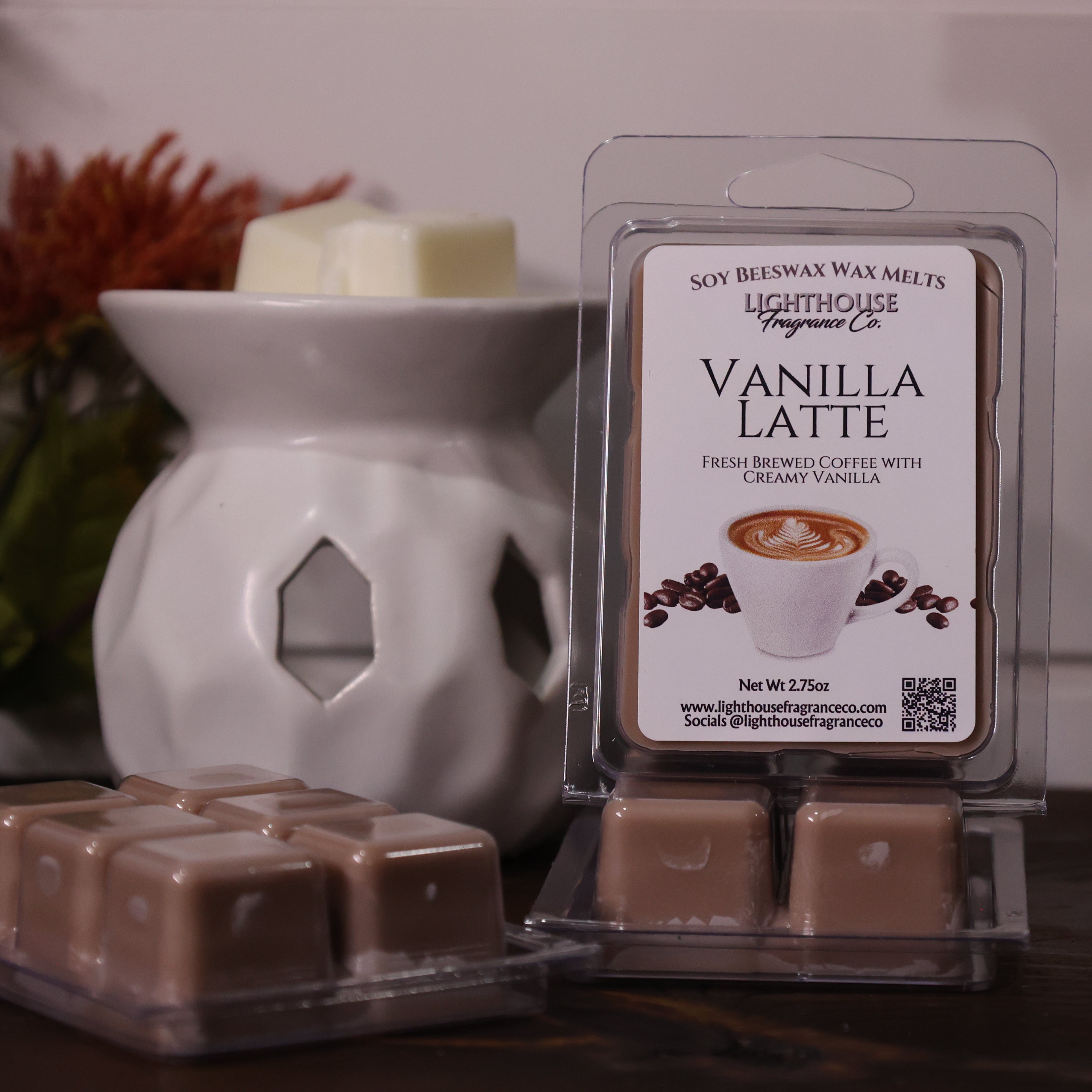 Vanilla Latte wax melt packaging with a white wax warmer and decorative items in the background.